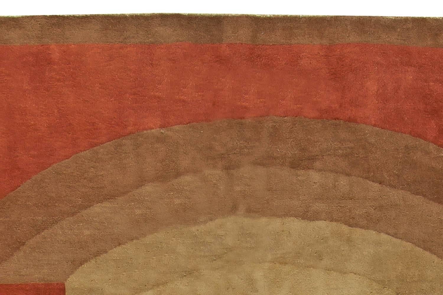 A modern second quarter of the 20th century Chinese deco rug, the rich red field dominated by enlarged brown and beige open geometric shapes within a think plain brown border.