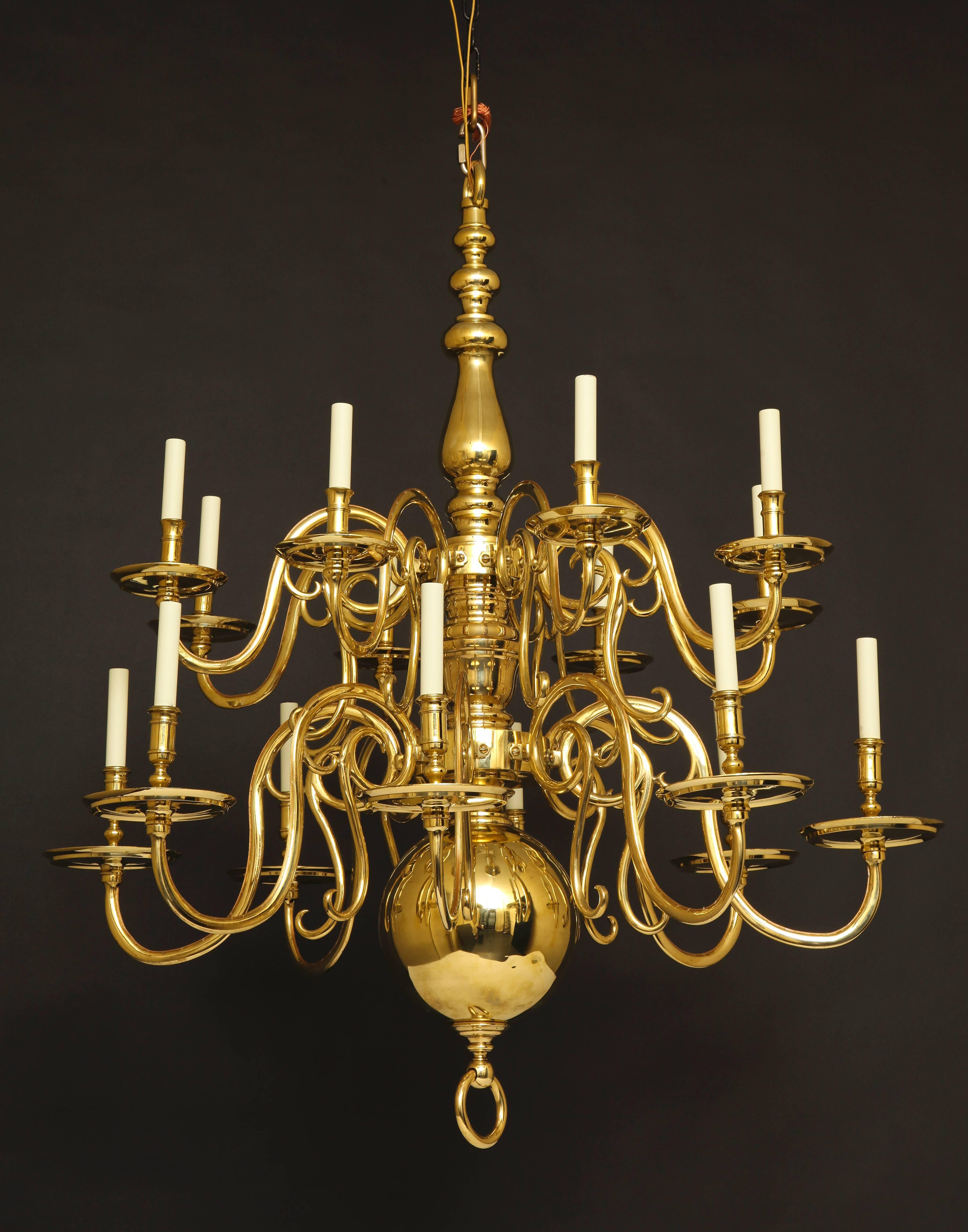 Large two-tiered Dutch Baroque 16-light brass chandelier with large ball bottom, finished with a loop finial.