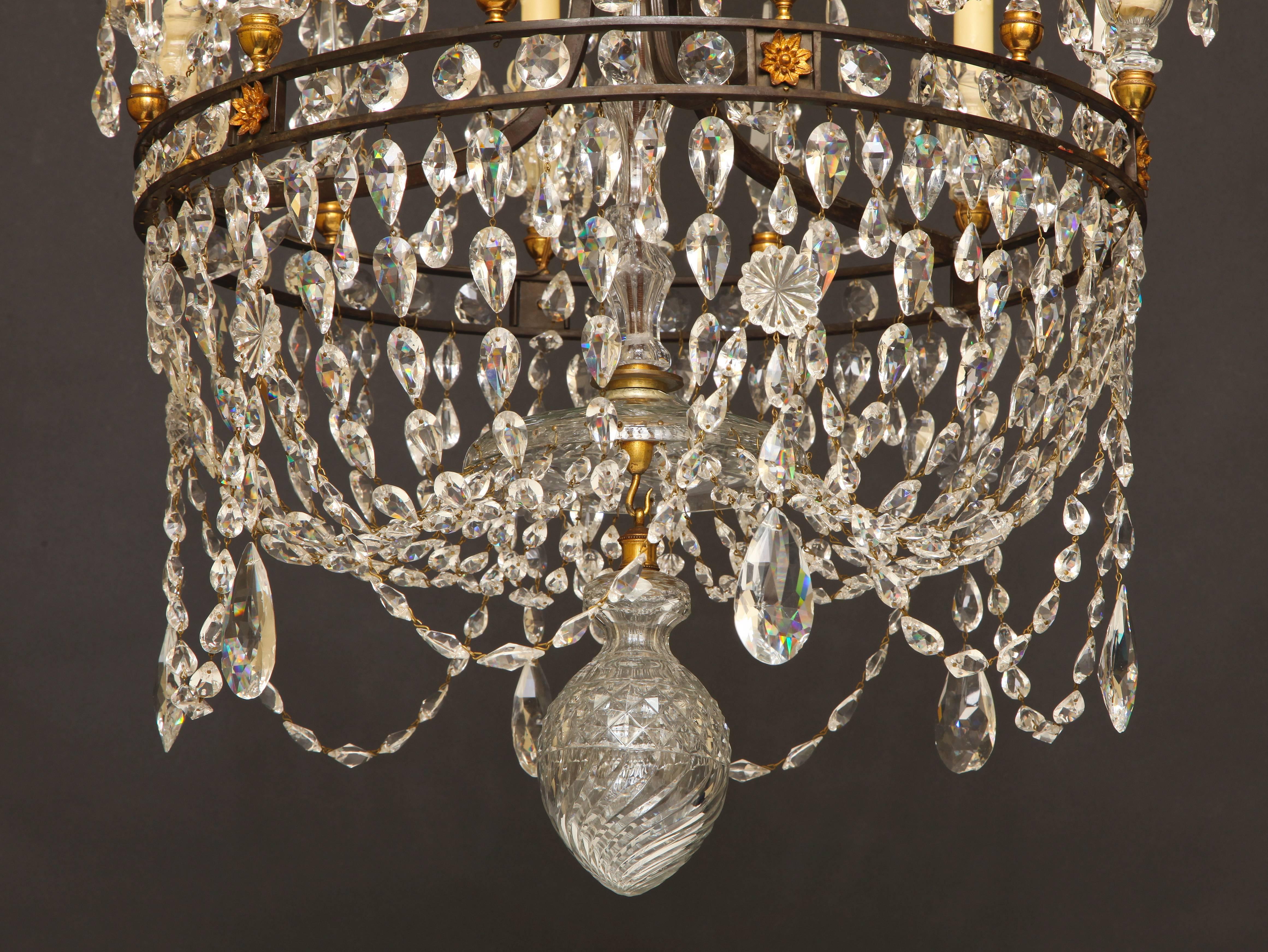 Faceted Crystal and Dark Bronze Six Light Waterford Chandelier With An Empire Basket Bottom.  The Crystal Candle Cups Are Made In The Van Dyke Style And the Center Shaft Has Swirl Cutting To Match The Exquisite Crystal Ball At The Bottom.  The