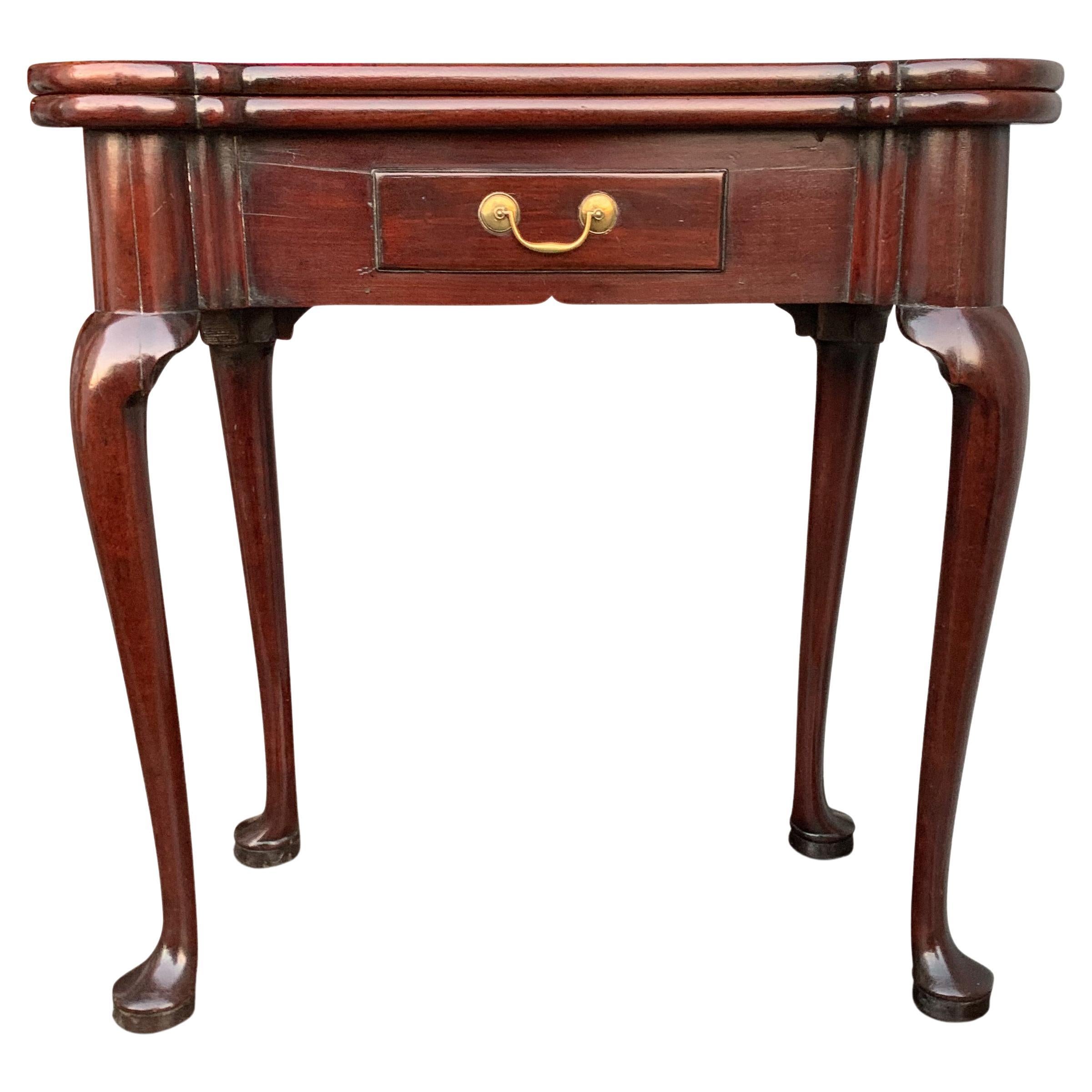 An exquisite Mid-18th Century George II polished mahogany fold-over tea table with cabriole legs on pad terminals finished with brass drawer handle.

As with furniture of this period in history Georgian pieces are generally made of wonderful
