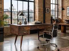 An Organic Timber Desk Befit with Five Drawers & Gilded Handles