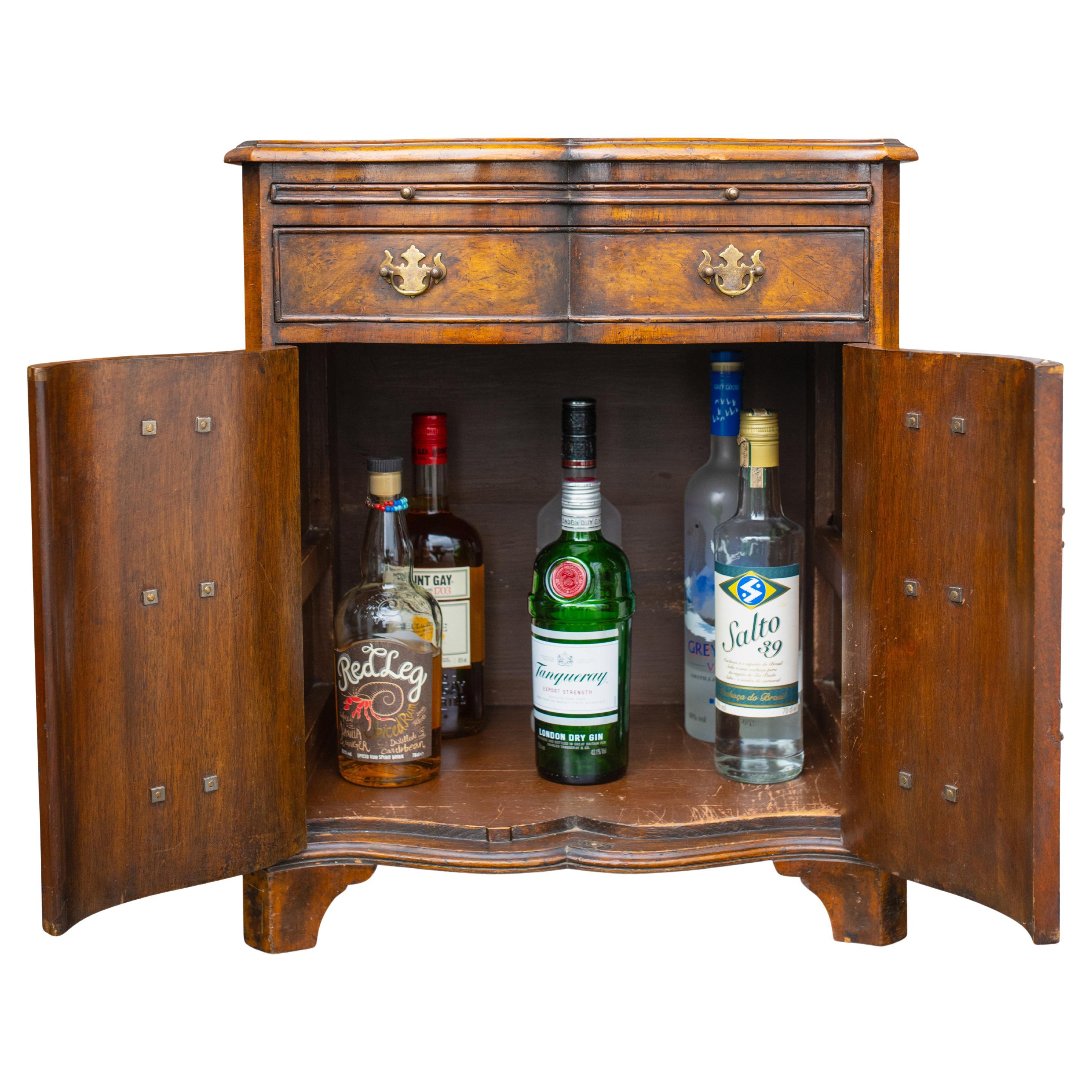 Burr Walnut Reverse Serpentine Two Door Batchelor's Drinks Cabinet With Single Drawer & Brass Bat Wing Handles in the Georgian Style.

Would work as a great lamp table, a solo nightstand or a petite drinks cabinet. 

