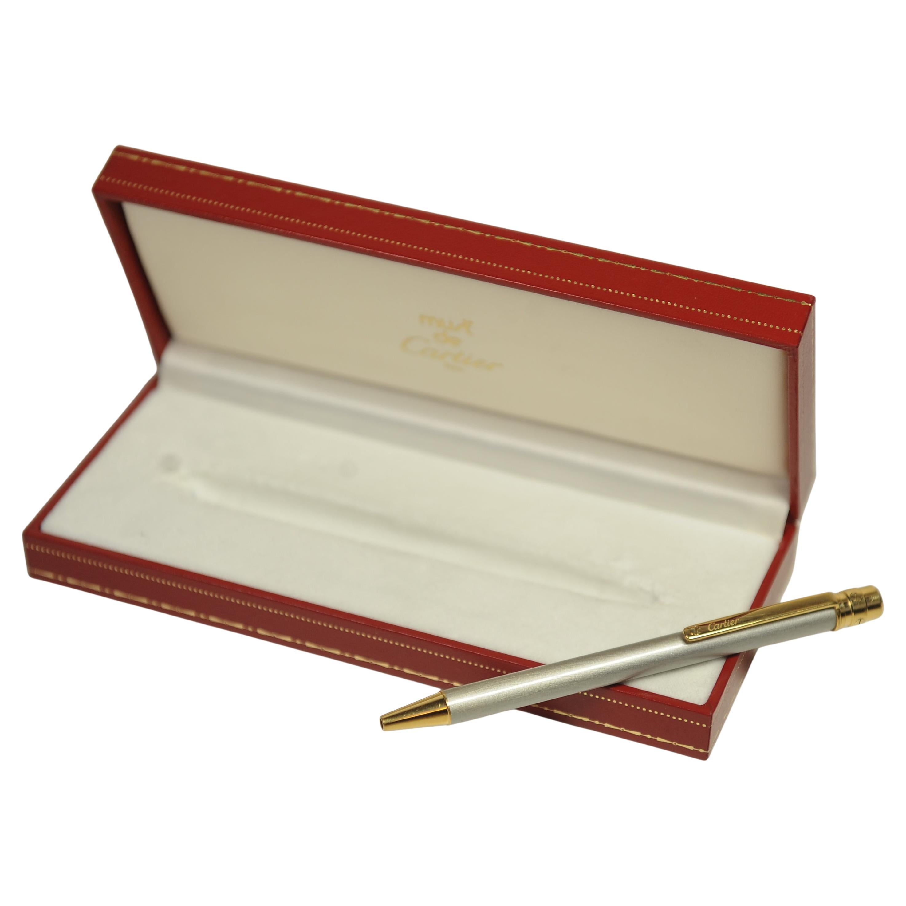 Elegant Cartier Brushed Steel & 18ct Gold Plated Santos Stylo Bille Must II 

Pen comes with Hard Case and Booklet 

Cartier pens are designed by Cartier, & are manufactured by Montblanc. This collaboration allows Cartier to produce high-quality,