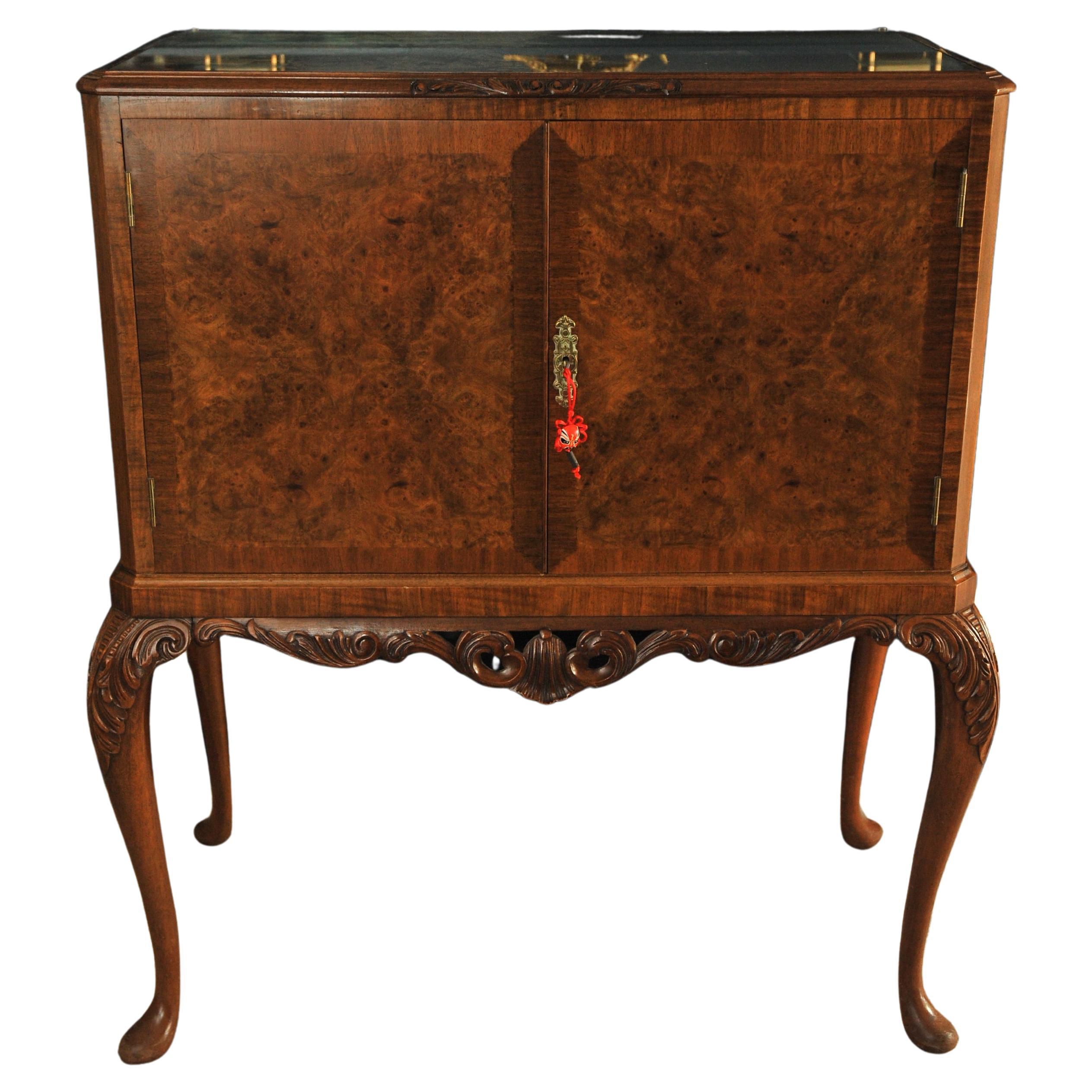A Luxurious Burr Walnut Cocktail Cabinet With A Fitted Light, A Mirrored Interior & Glazed Secured Top. 

Cabinet is fitted with an internal working light, which has a UK three pin plug (not PAT tested).

Inside features a well made dovetail drawer
