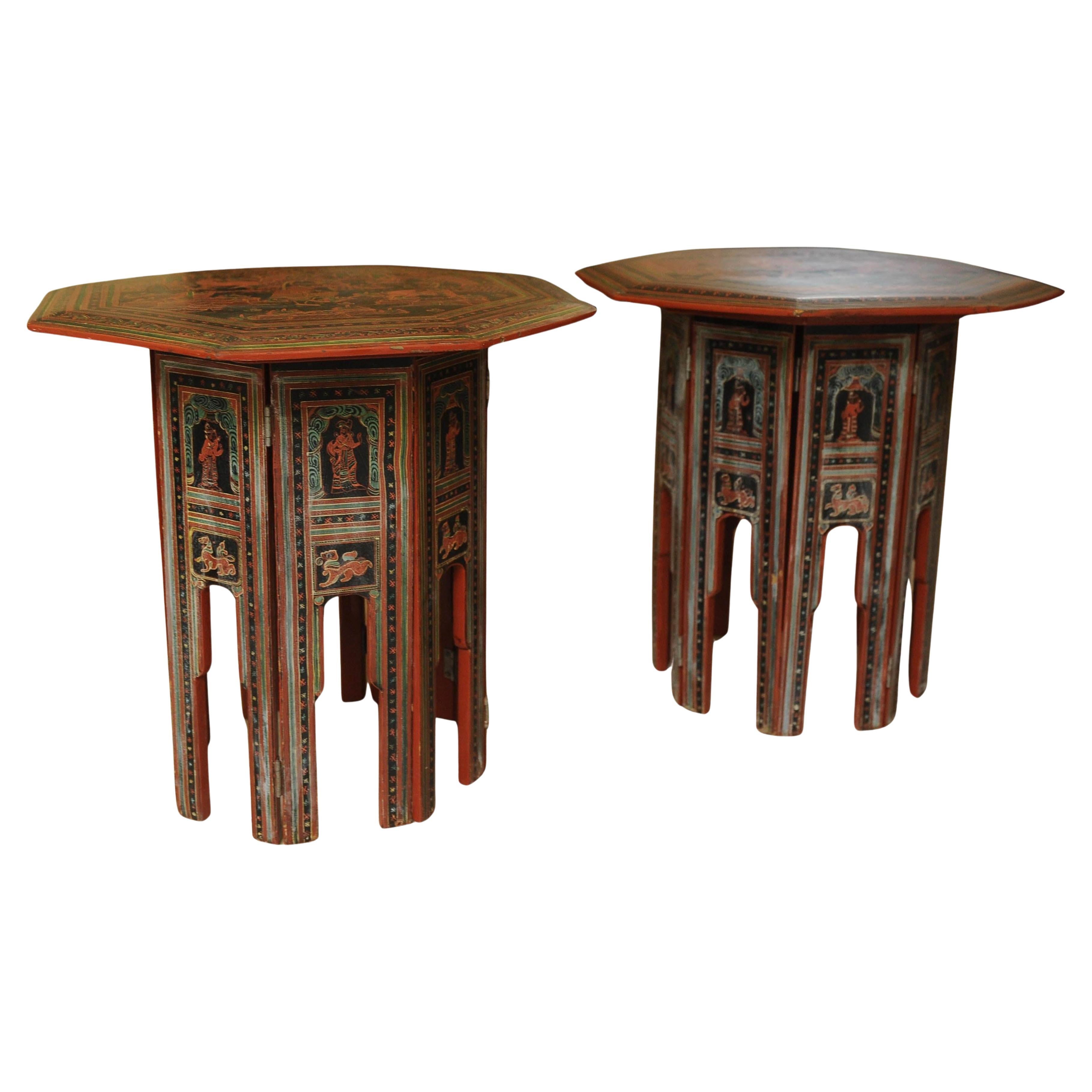 A Pair of Victorian Liberty of London Style Eastern Folding Tea Table With Paintings 1890s

Decorated with images of figures, birds, animals and mythical creatures.

Both table tops lift off from the base and the base can be folded.