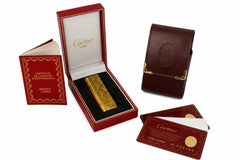 Accendino Cartier placcato in oro 18 carati e portasigarette Cartier in pelle bordeaux