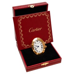 Réveil de voyage ovale miniature Cartier en or plaqué, dans son coffret *Frais d'importation offerts aux États-Unis*