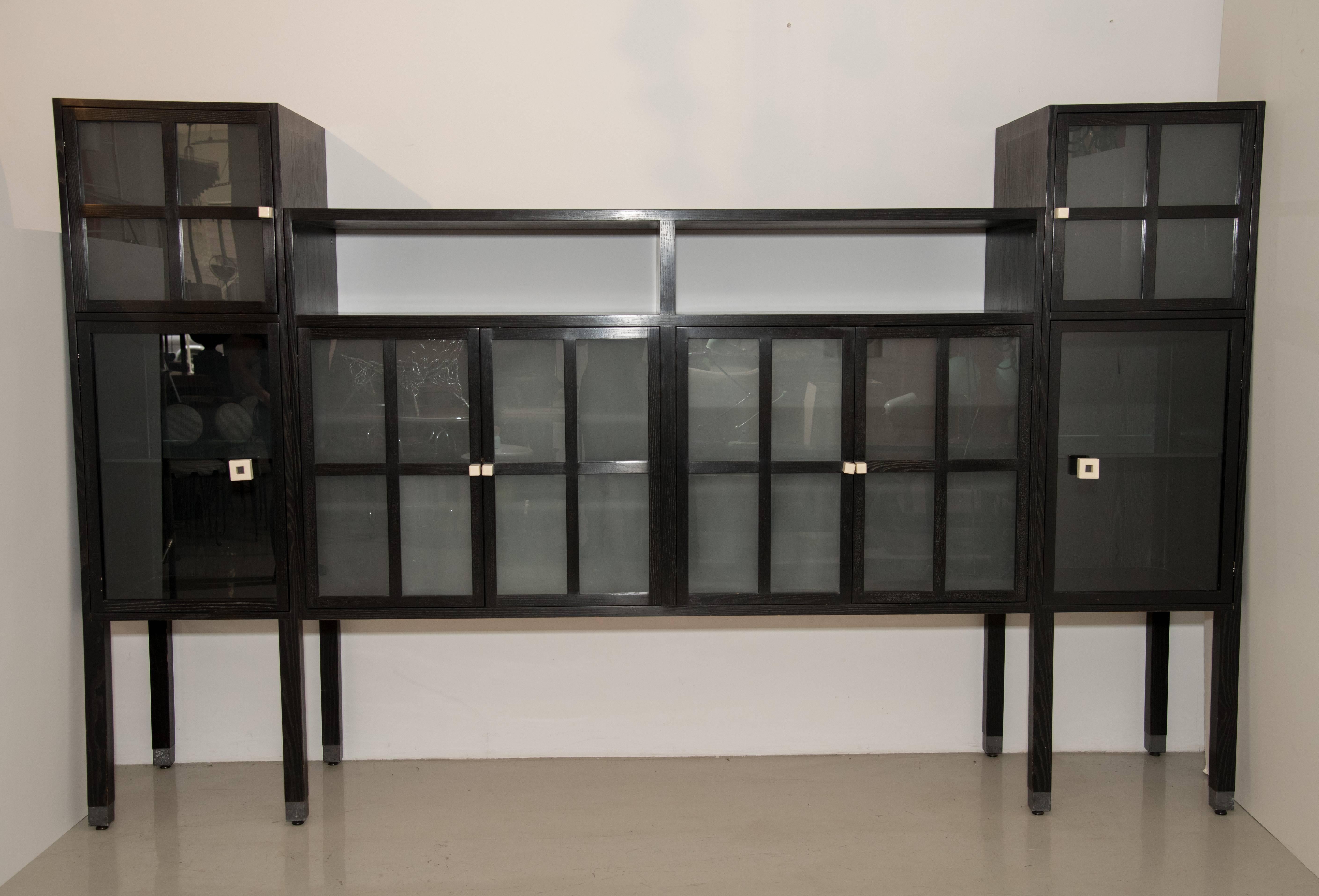 This fabulous cerused ash and sandblasted glass entertainment cabinet, buffet, bar, or even bookcase cabinet has wonderful storage and a very modern look. It is called the Piombo cabinet. This is Leon Rosen for Pace. It has glass and wood shelves.