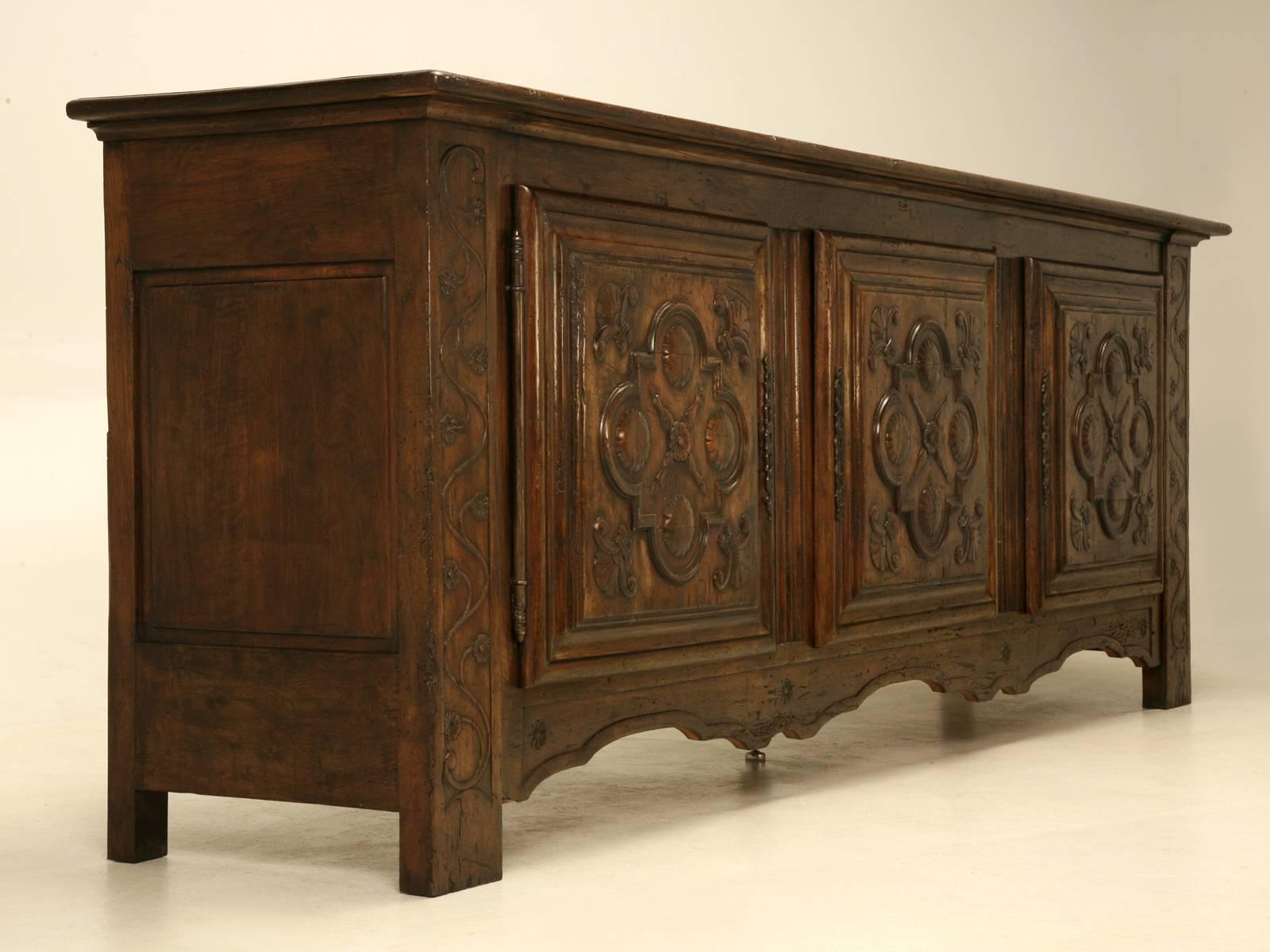 An unusually large scale antique Spanish buffet that has the appearance of an 18th century piece, but we believe it was made in the early 1900s to look like it was 200 years older. Incredibly heavy construction and will undoubtable last forever.