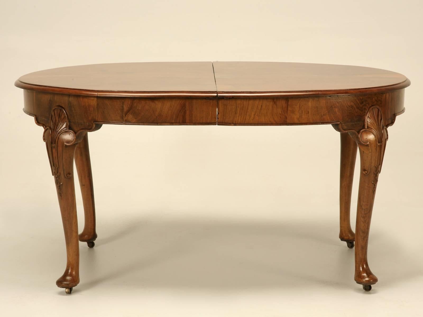 Antique English Chippendale style oval table from the 1800s, with two burl walnut leaves. After our workshop inspected the table for structurally stability and functionality, we sent it into finishing, where we removed layers of old dead finish we