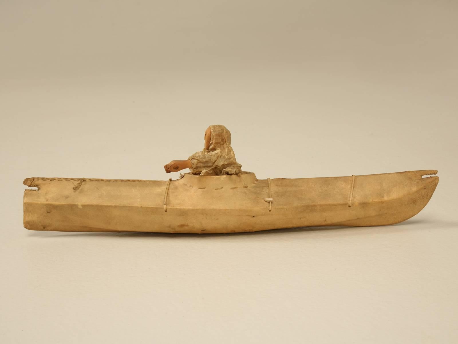 Constructed over 100 years ago, this Eskimo kayak is made from seal skin tightly wrapped over a wooden skeleton frame. The fisherman is original and is covered in a paper thin tanned hide. This is just one of several we will be offering on 1stdibs