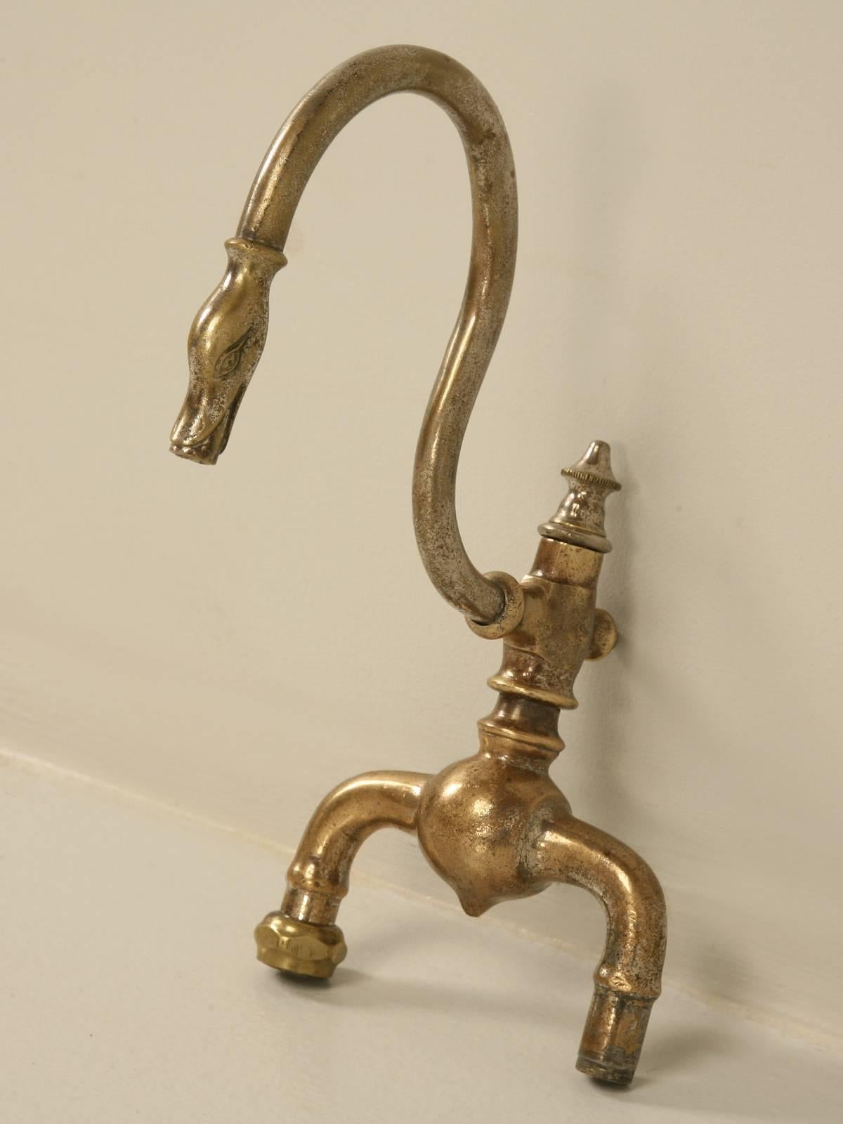 Antique French swan neck faucet in solid brass with a mostly worn off chrome finish. And before you ask, no we did not try to use it, so you have to assume it will require new gaskets.