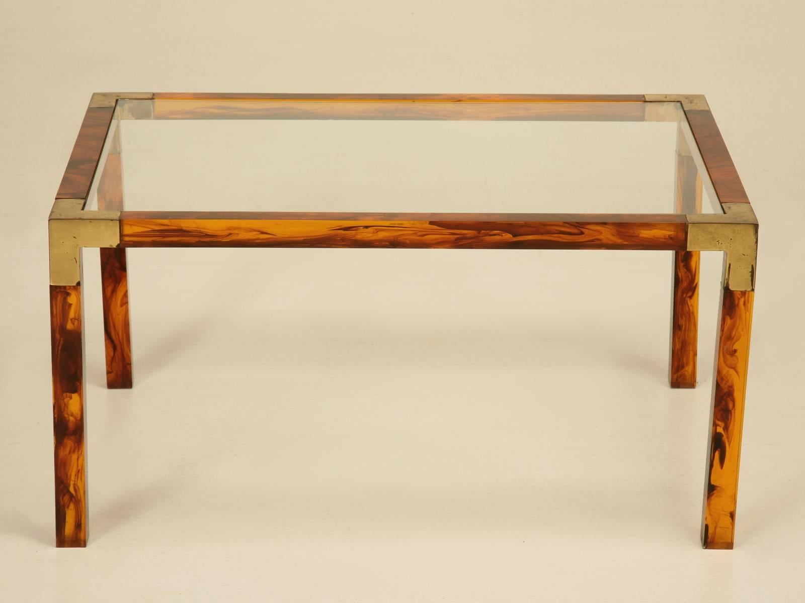 Faux tortoise shell acrylic and brass petite French coffee table. This has to be one of the most unusual and elegant tables we have ever had and I am sure they were mass produced, but we have never seen one before. Please note the patination on the