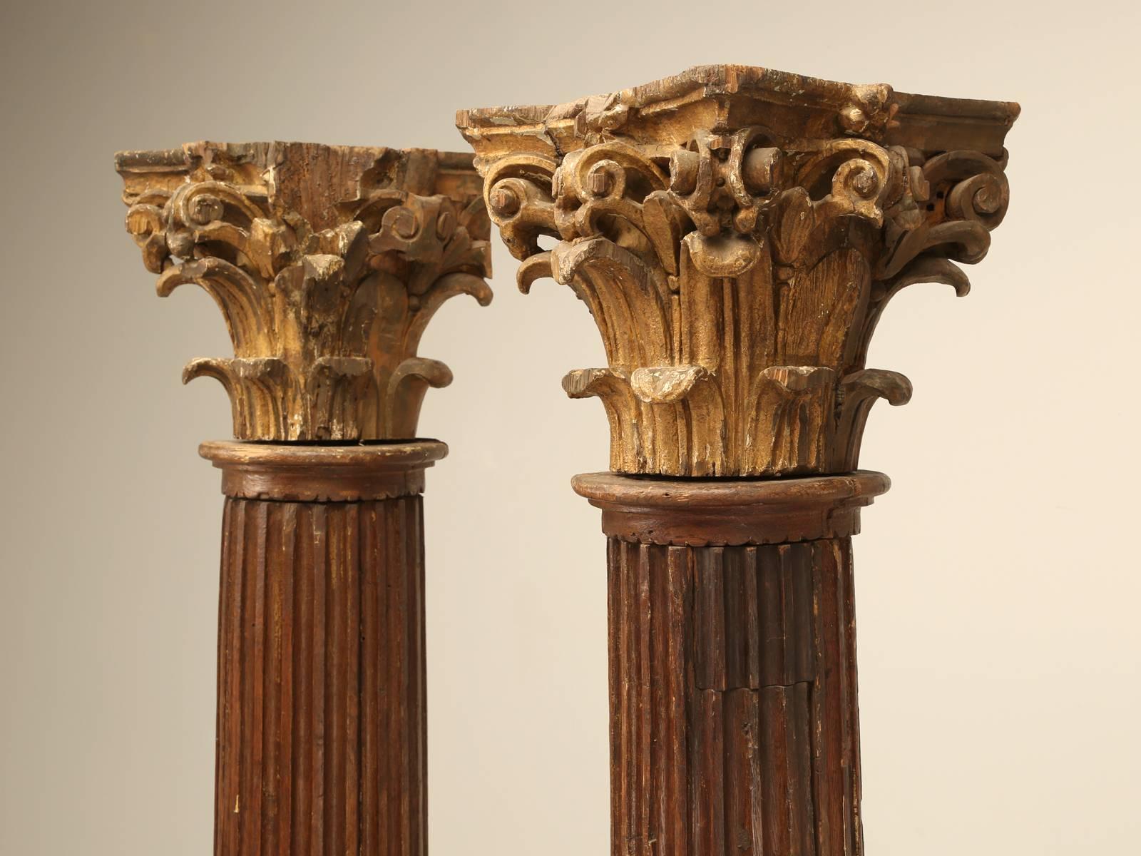 Circa 1800-1820 French fluted oak beautifully hand-carved corinthian columns in their original finish with gilded capitals. We purposely left the columns in as found condition, and can restore them to any level you would like. They can also be