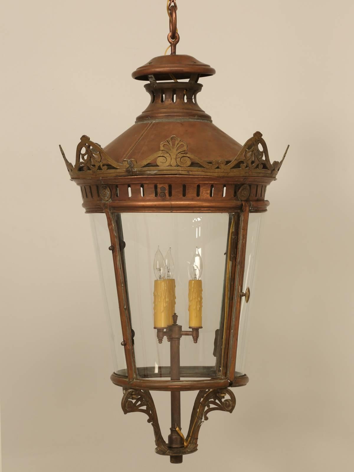 French antique lantern that is old enough that was it never electrified, so we had our Old Plank electrical department wired it for three 60w candelabra bulbs. The curved side lights are still fitted with glass, unlike so many that have been