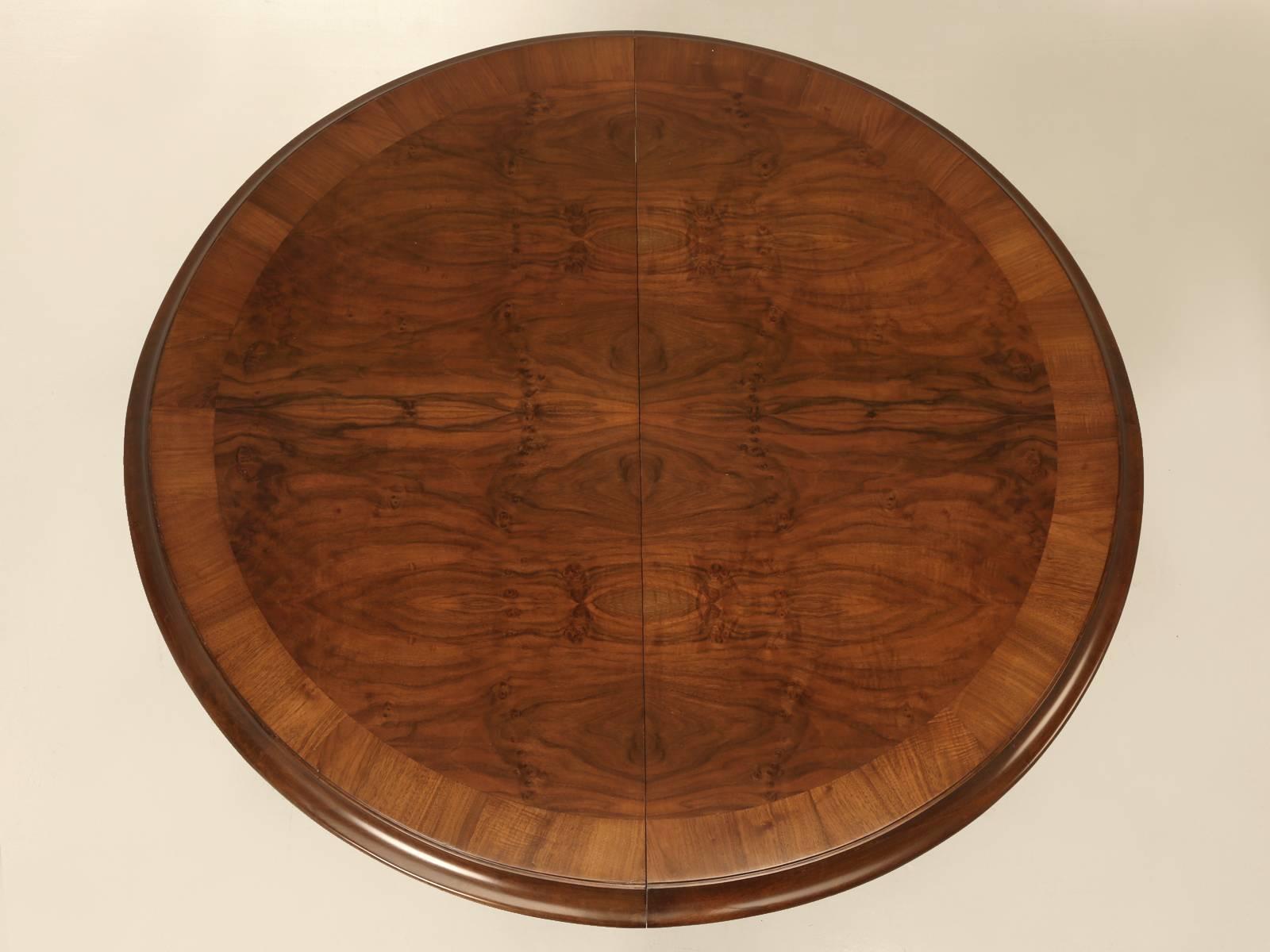 Beautiful bookmatched burl walnut French dining table with a banded edge, that our Old Plank workshop just completed a thorough and proper restoration. The table will seat a tight six without the leaf and eight people when it is installed. Although