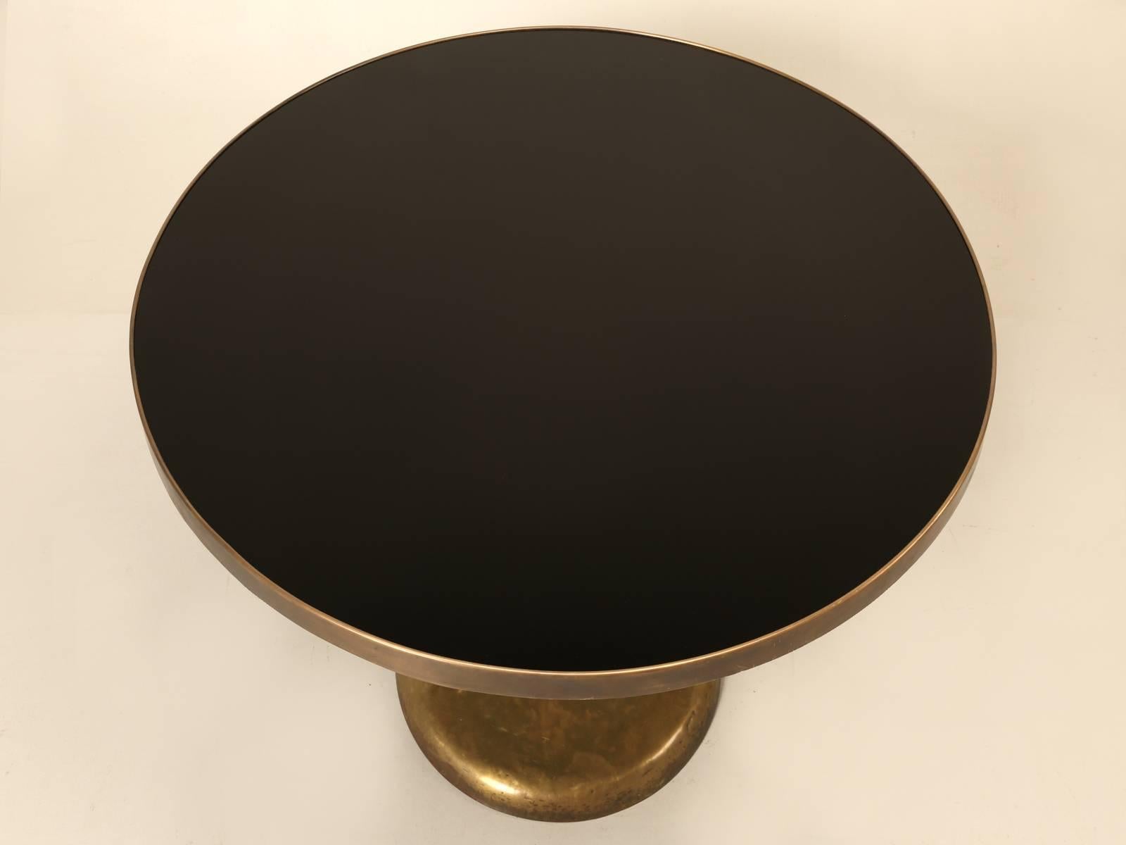 Although we purchased this stunning dining table in the south of France, we are thinking it could be Italian and probably crafted between 1940 and 1960. Constructed of hand-hammered brass and black glass. The table is both elegant and user friendly