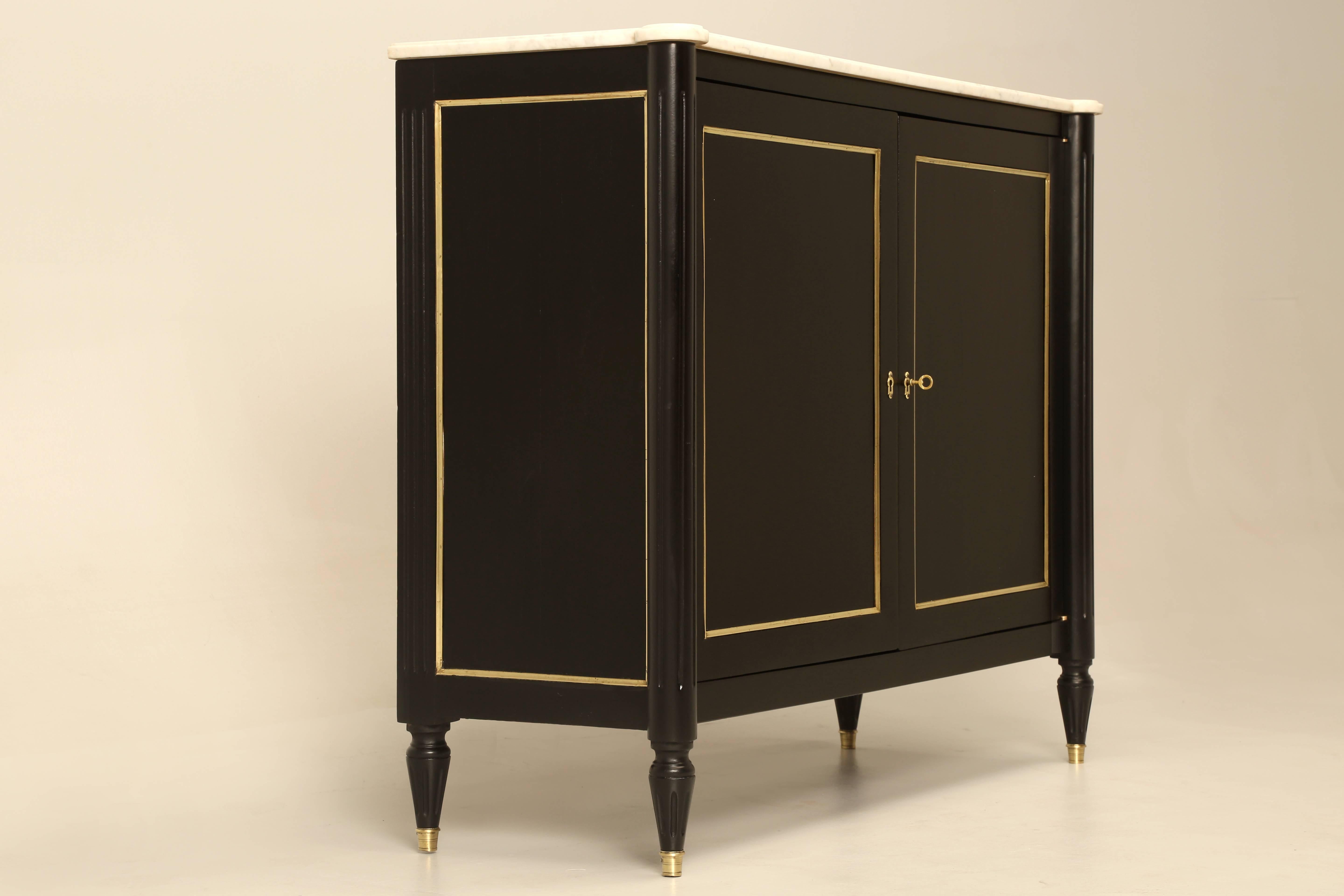 Very unusual two-door Louis XVI style buffet, with a fitted interior. Beautiful solid mahogany cabinet that was hand scrapped and sanded (no chemicals used) before we applied an old fashion ebonized finish, that still allows for the graining of the