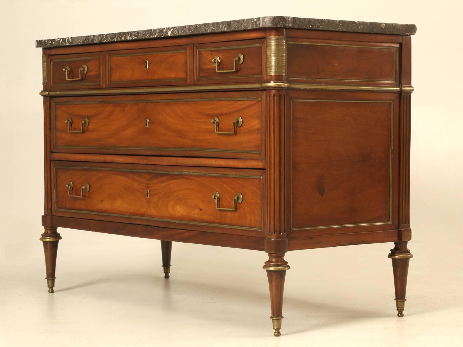 Antique French commode in mahogany with a Sainte Anne grey marble top. The graining of the boards chosen for this chest were so beautiful that we simply could not bring ourselves to ebonize it and even knowing it would probably take longer to sell.