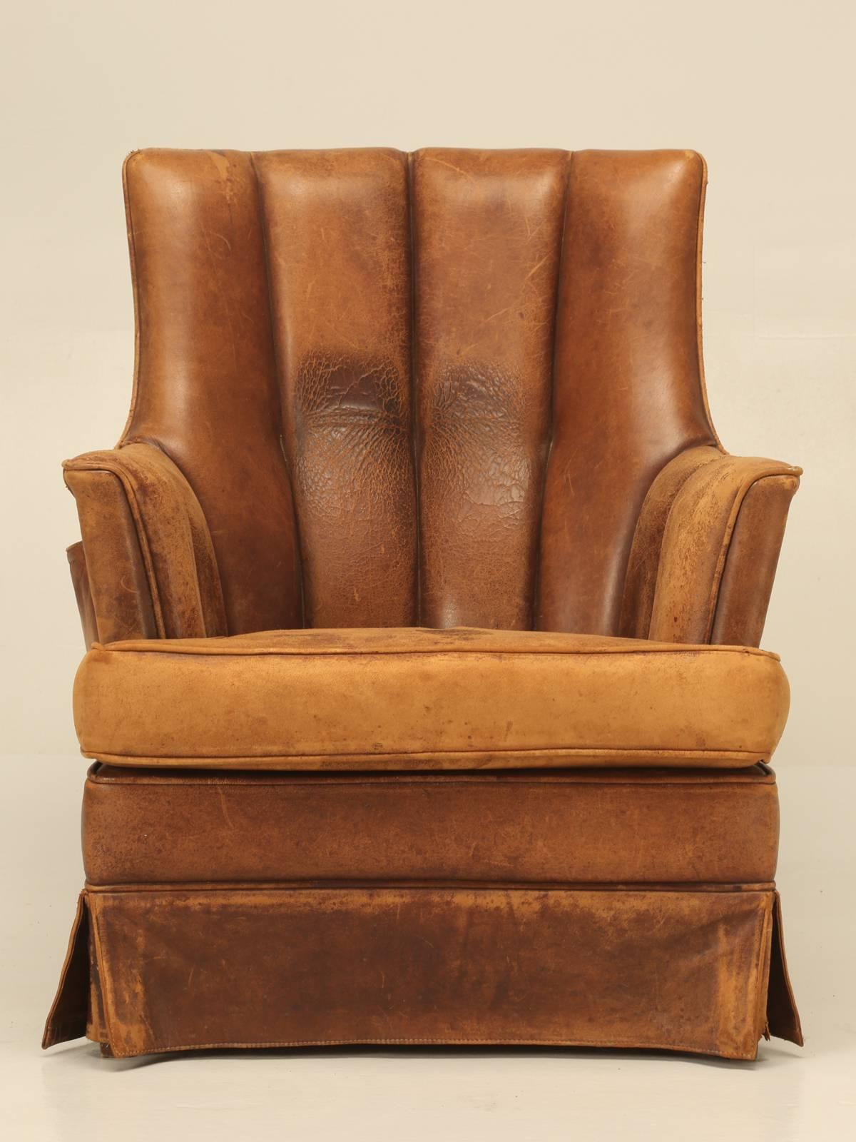Incredible comfortable, all original (still supple) leather skirted 1940s, French club chair, with a built-in magazine pocket and I have to say, that this was a first for us. Large enough for a good size man, but not too big for a petite woman; just