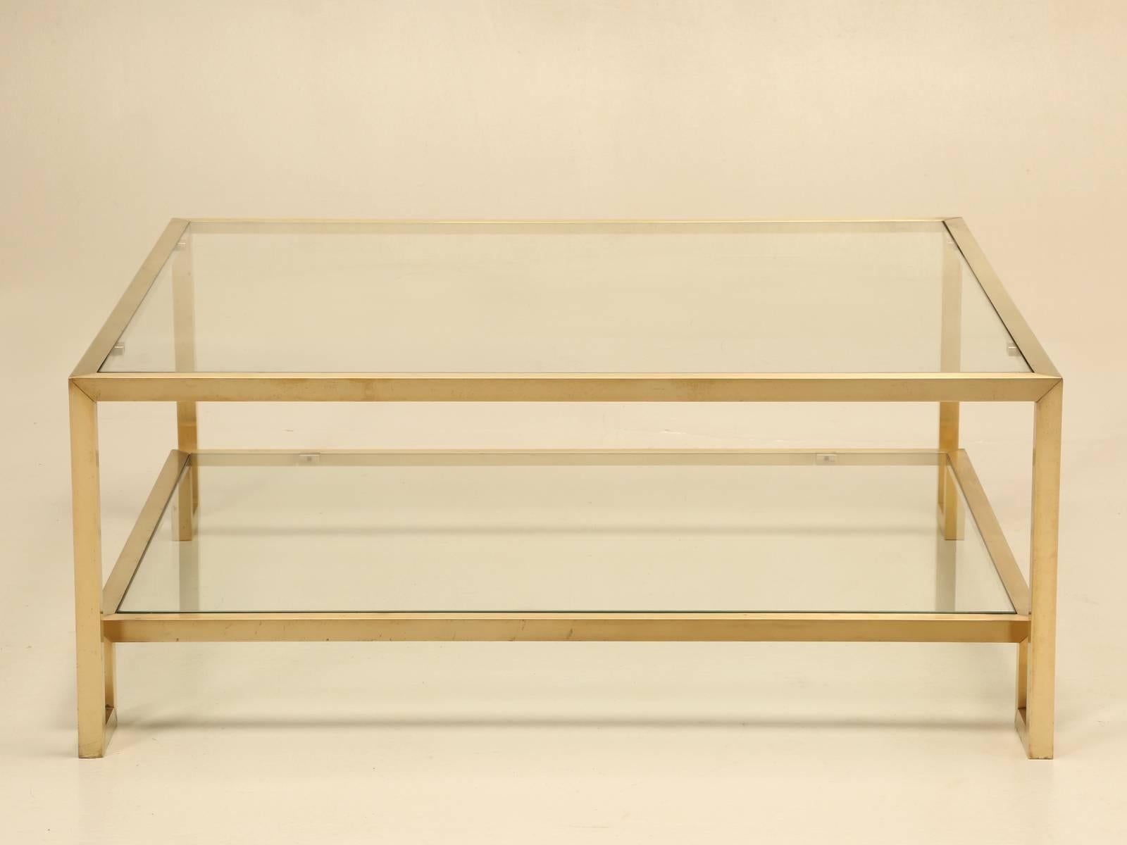 Designed by Guy Lefevre for Maison Jansen and probably made in the early 1960s. Constructed from solid brass, which should not to be confused with a brass-plated steel table as most are. Two-tier Classic Mid-Century Modern design and please note a