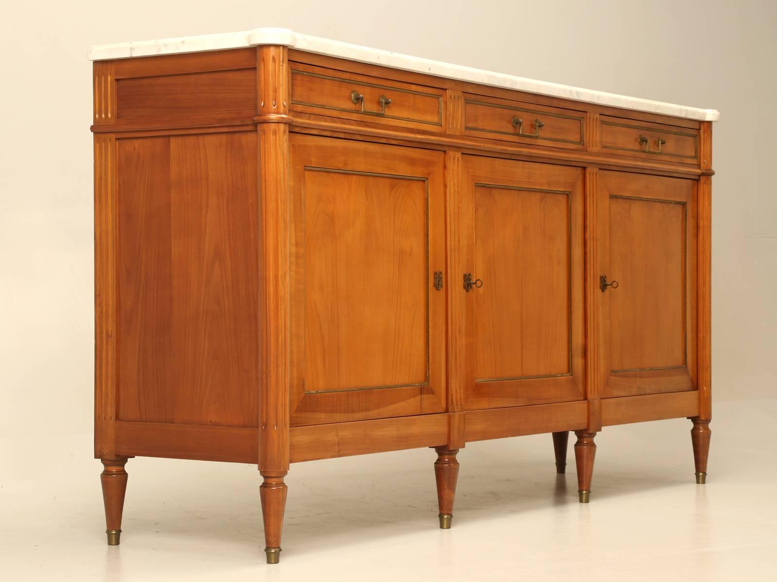 Classic Louis XVI style three-door buffet, made of French cherrywood and a little nicer quality than most. The drawers are dove-tailed front and back and they drawer bottoms are a hardwood and not that flimsy plywood that was commonly used. The