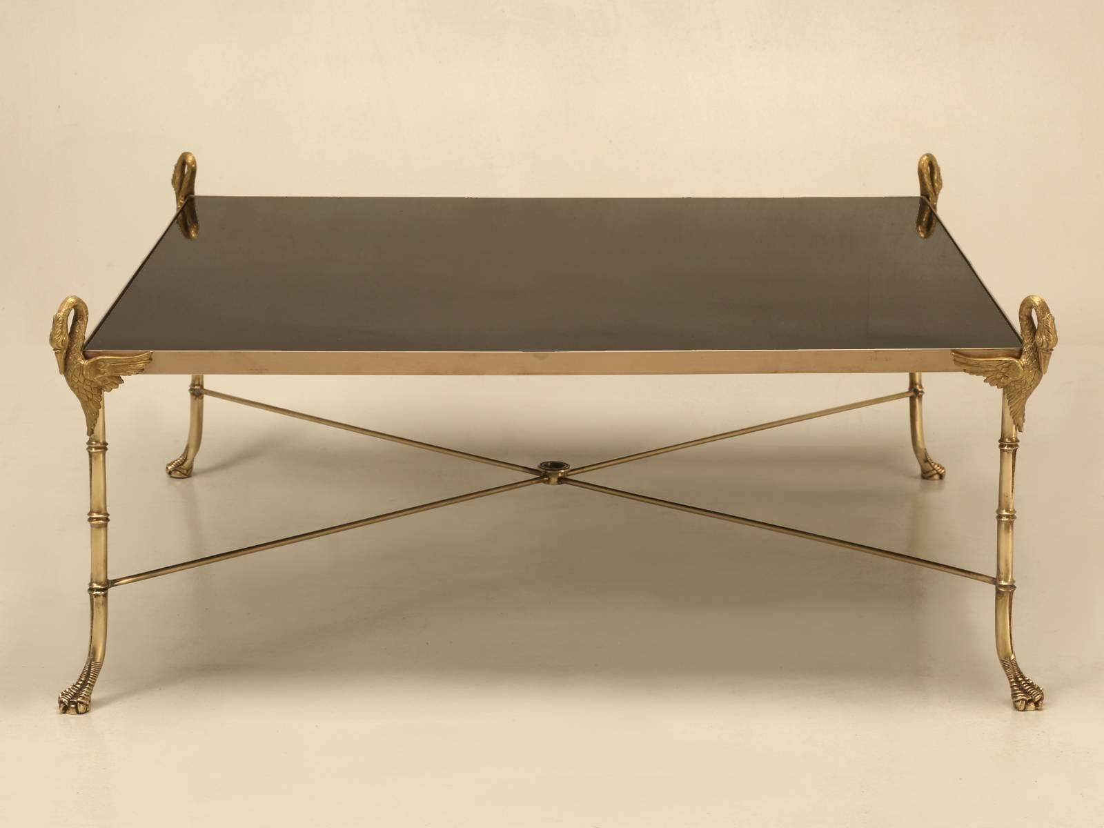 Beautifully crafted, French Mid-Century Modern Swan motif coffee table, made from solid brass and black glass. Whomever made this table in the 1960s, went to exceptional lengths to give it a feeling of quality and so many miss the mark when you