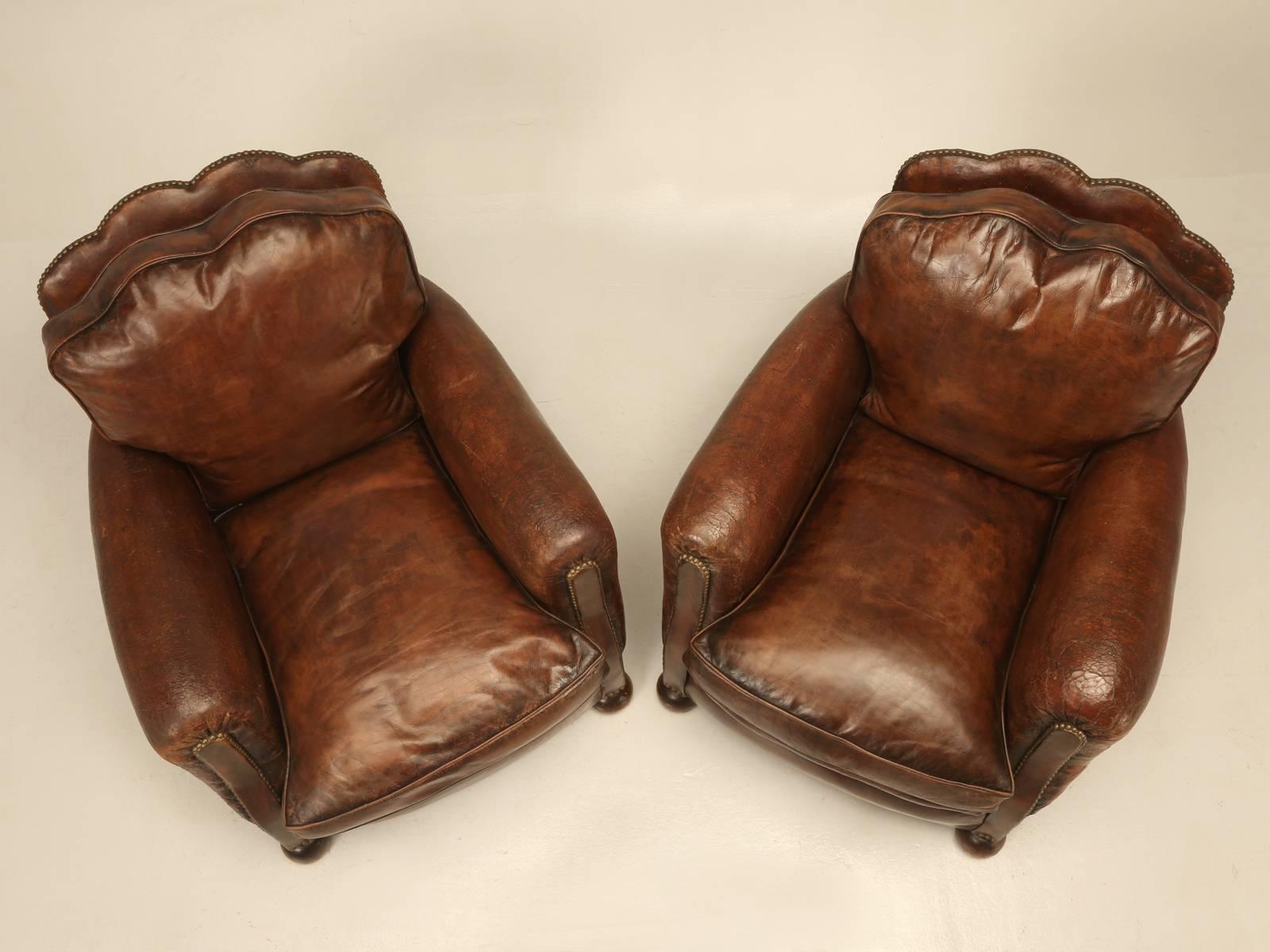 Pair of French leather club chairs that our Old Plank workshop and upholstery department restored from the bare wooden frames up. We generally stock between 75 and 100 leather French club chairs and as time allows, we pullout a pair and start the