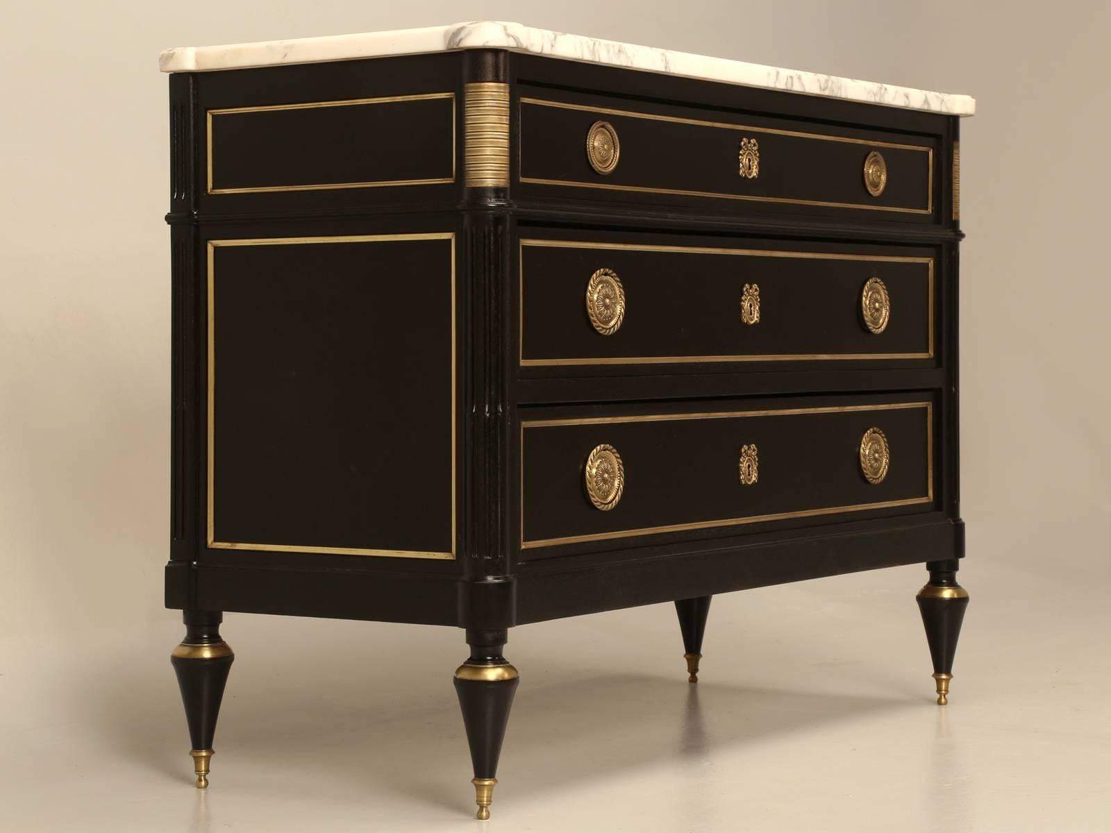 Antique French Louis XVI style commode that our old plank restoration department completely restored from the bottom up, including hand-stripping, without the use of chemicals and finishing with a proper ebonized finish which allows for the grain of