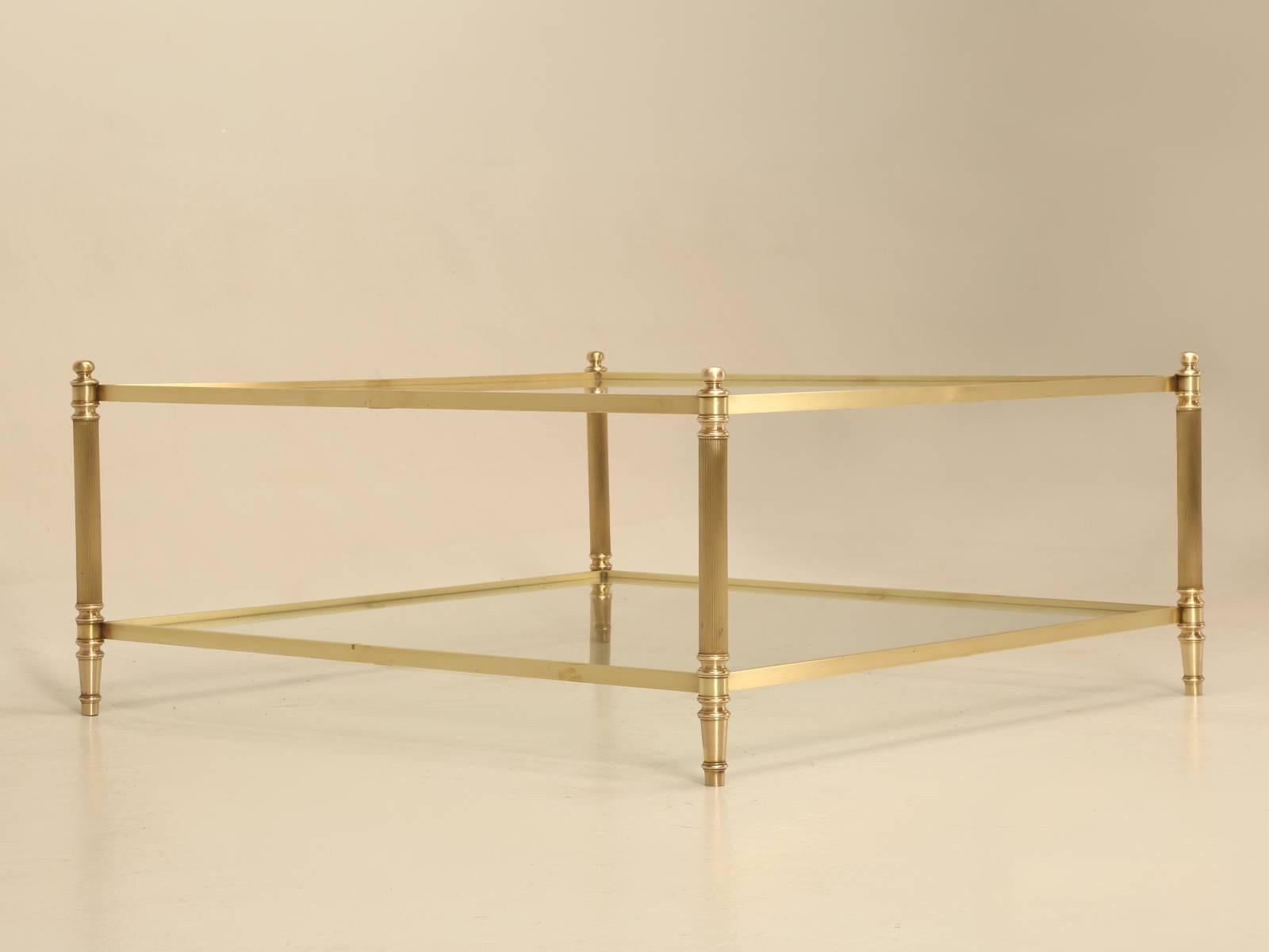 Classic French Mid-Century Modern 1960s-1970s brass and glass coffee tables are generally quite common; we have found it much more difficult to obtain the larger square two-tier tables. During our last visit to France, it seemed that we found the