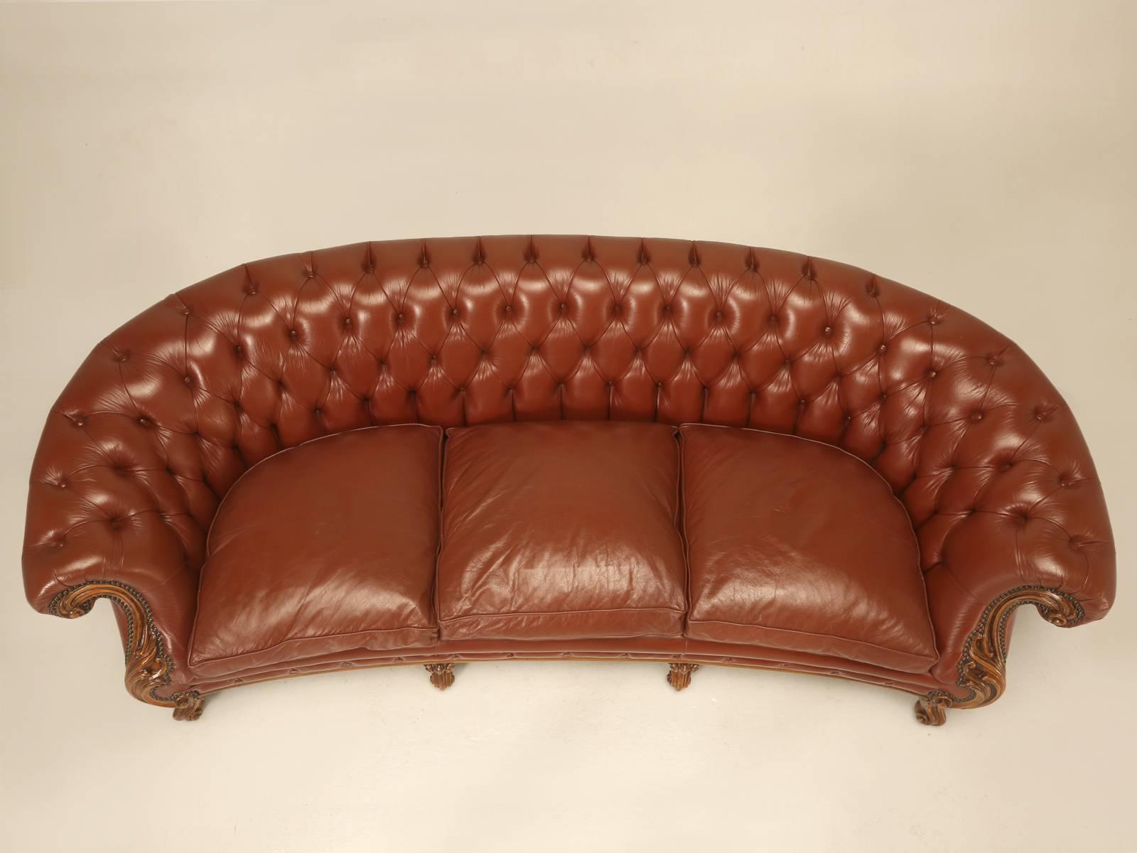 French leather tufted sofa, in the Classic Chesterfield style. The sofa is presented in an as found condition and this generally would indicate that repairs would be required, but in this particular instance, the leather sofa arrived to us in mint