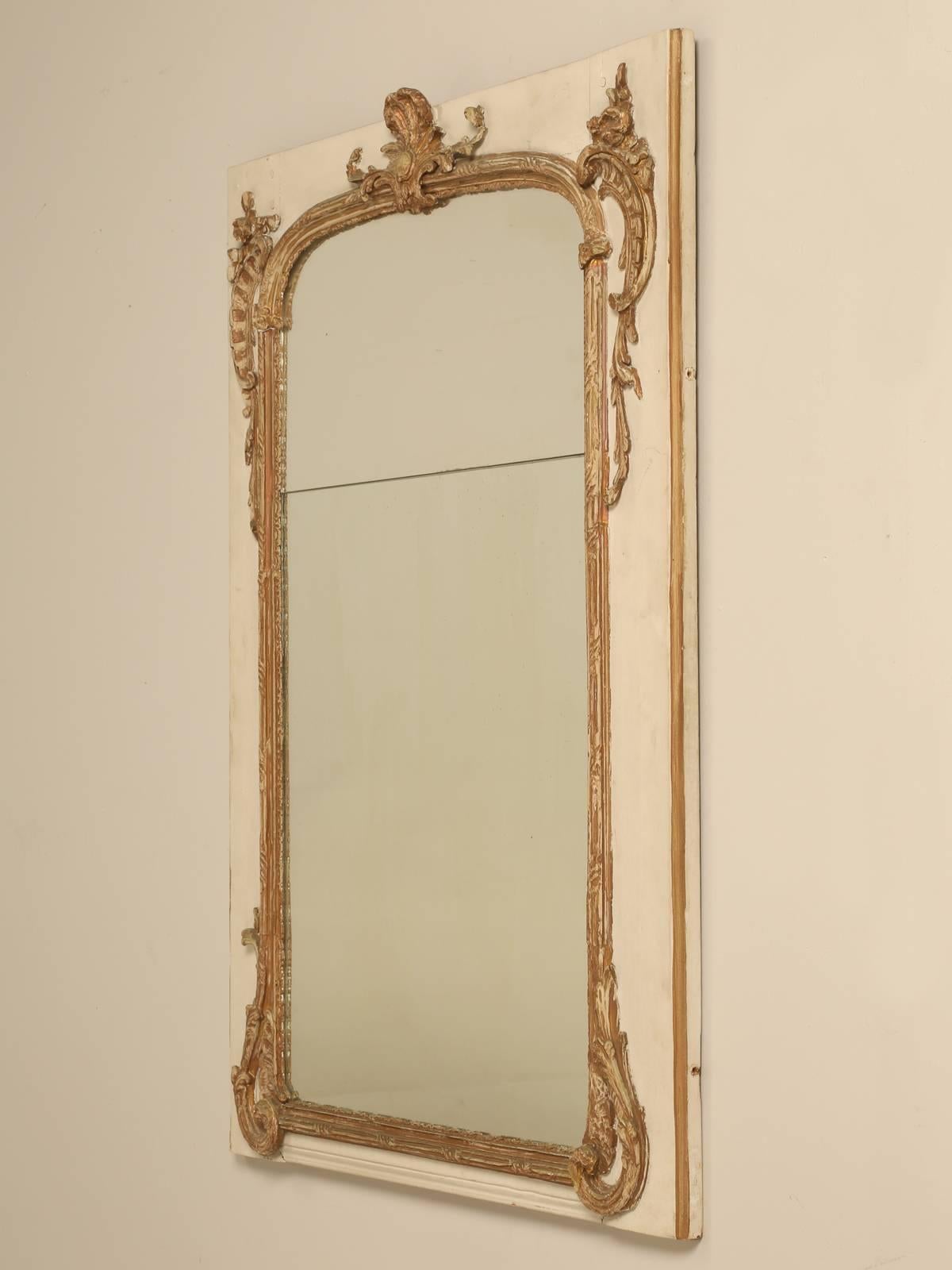 Very original antique French gilt mirror, with what appears to be the original two-piece glass. Not sure how well it photographs, but the mirror does show a nice patina. The gilding on the French mirror is all original and well worn, but the painted