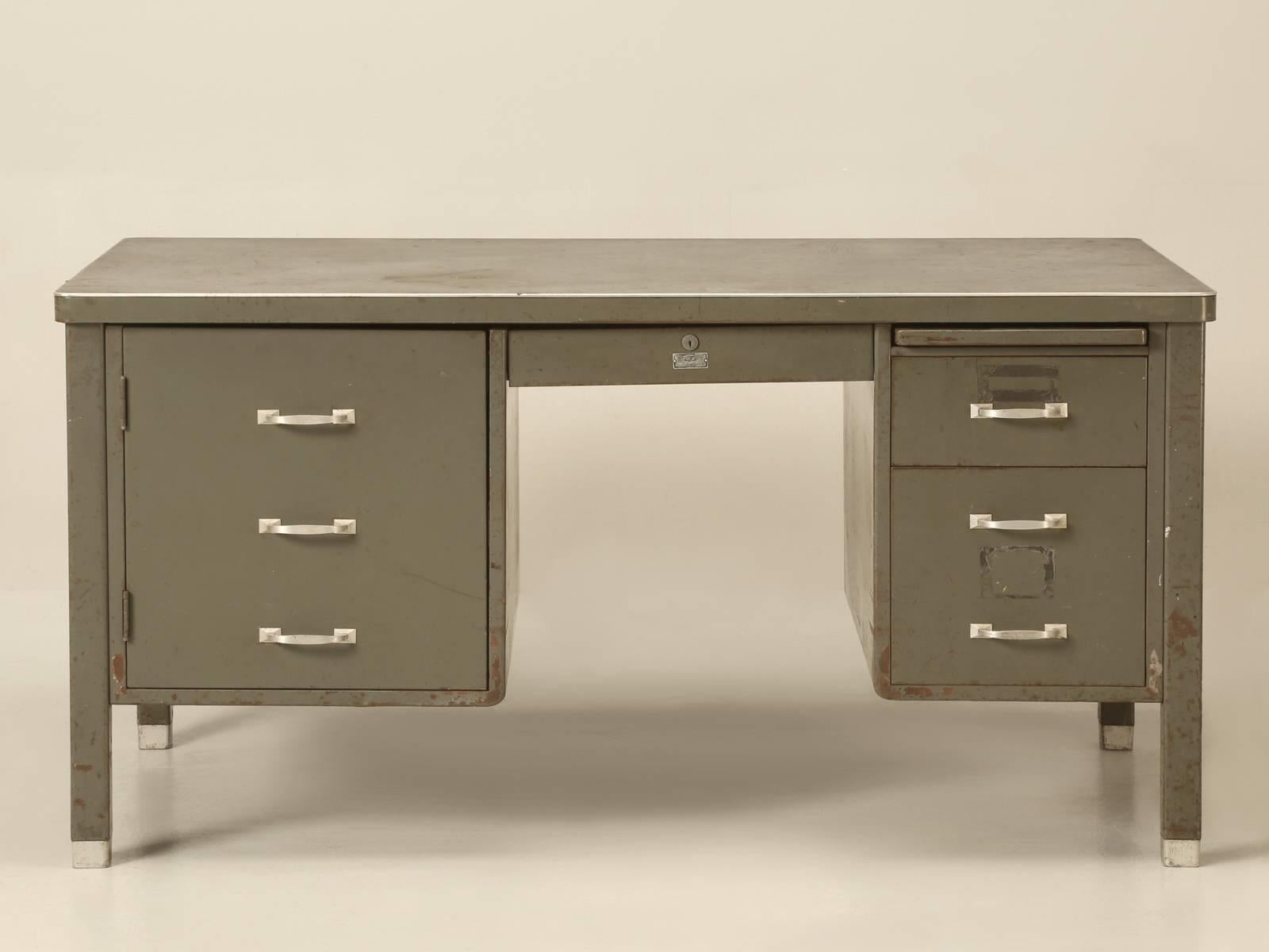 Typical American 1950s Industrial desk, which were built to last forever and offered in as found condition, meaning no one has tried to restore the paint and actually made it worse, by not leaving it alone.