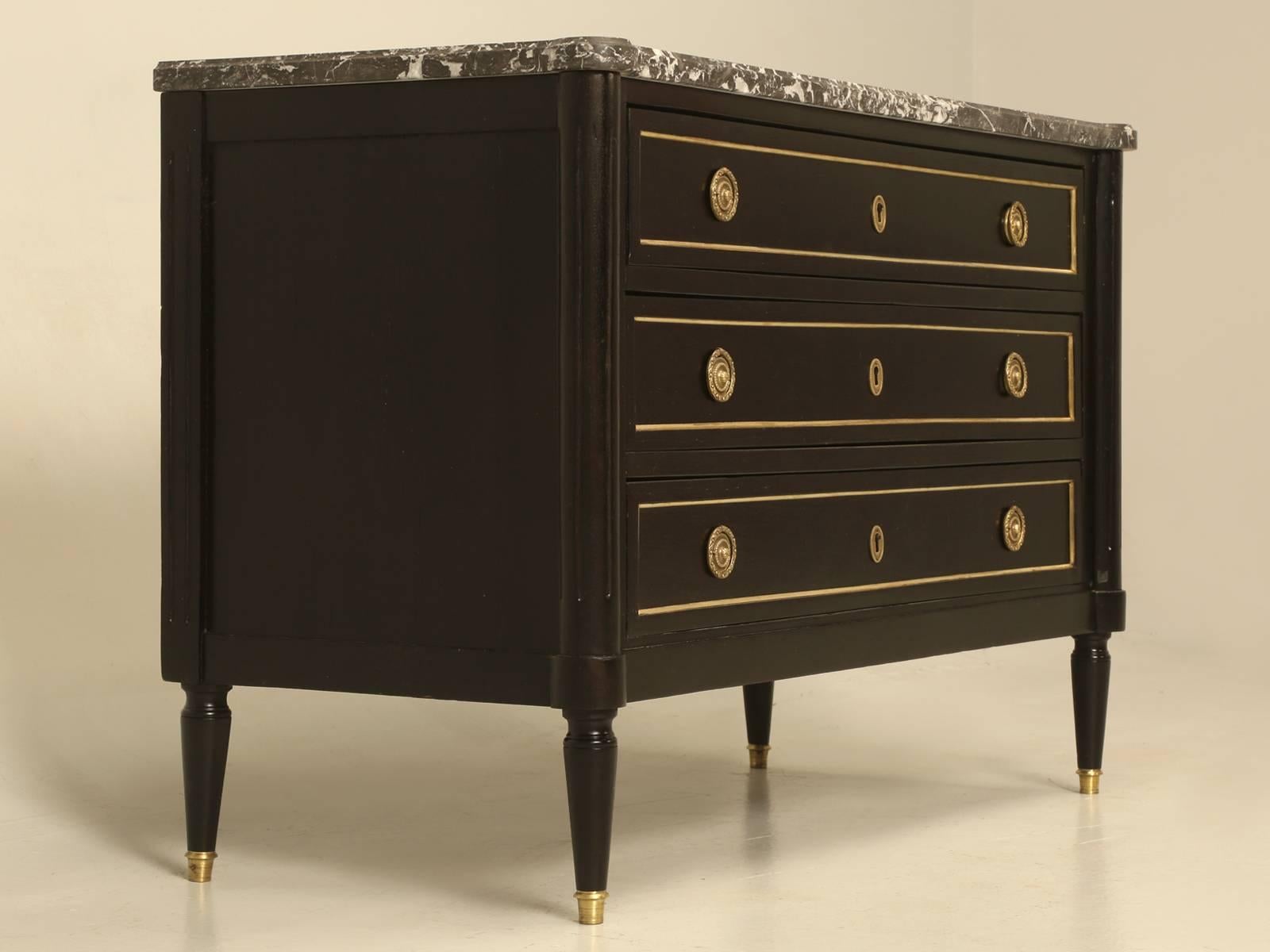 Antique French Louis XVI style ebonized commode. Our Old Plank restoration department restored this French Louis XVI commode from the bottom up and started by rebuilding the case, each drawer and hand-scraping the old finish off. Our finishing