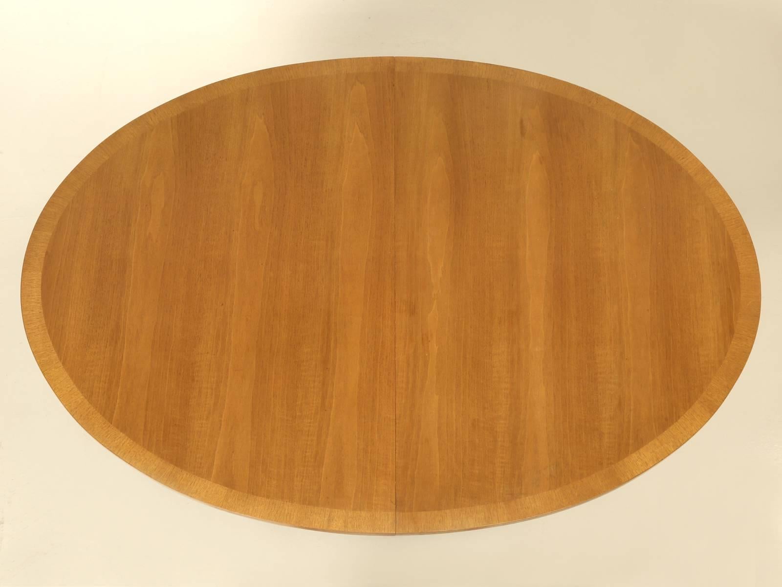 Manufactured by the Sligh Furniture grand rapids chair company in Michigan. This Mid-Century Modern dining table with two matching leaves has a Scandinavia style to it. Nice original condition and had never been repaired or refinished. We have the