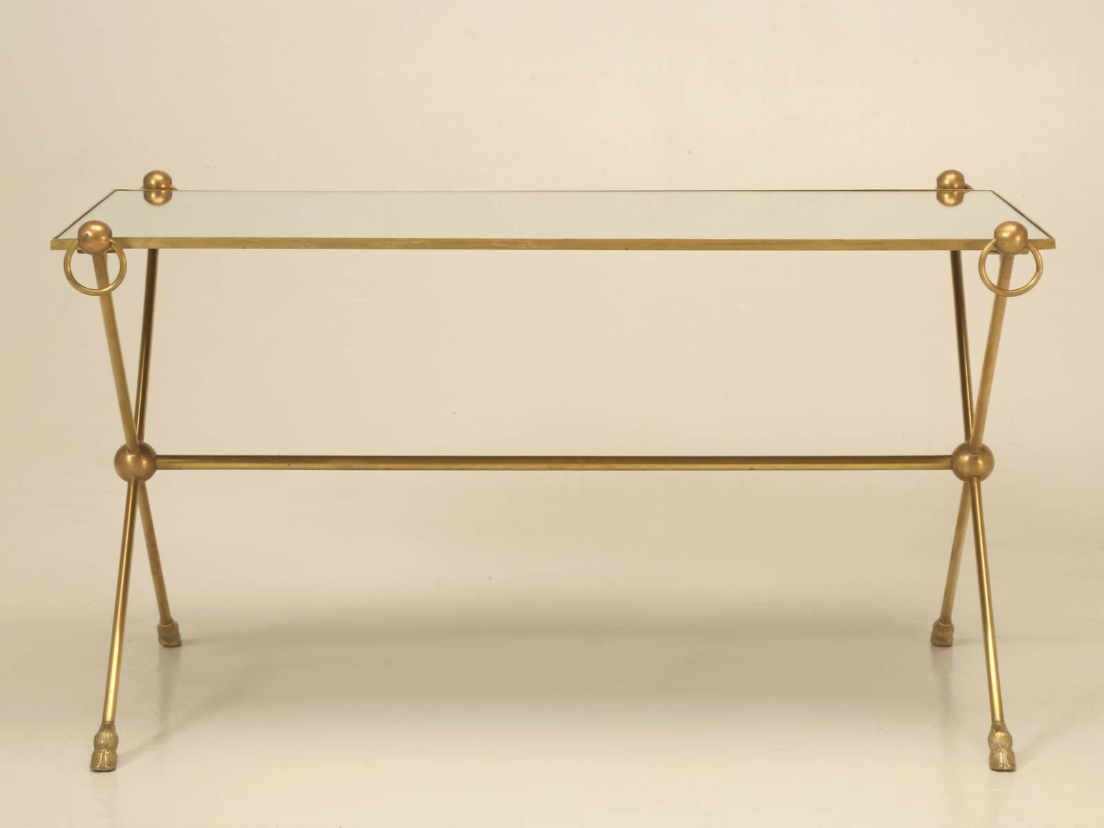 French Mid-Century Modern petite coffee table with four decorative rings, complimented by a lovely solid bronze hoof foot detail. The mirror top has been replaced and is very near perfect, with no obvious scratches.