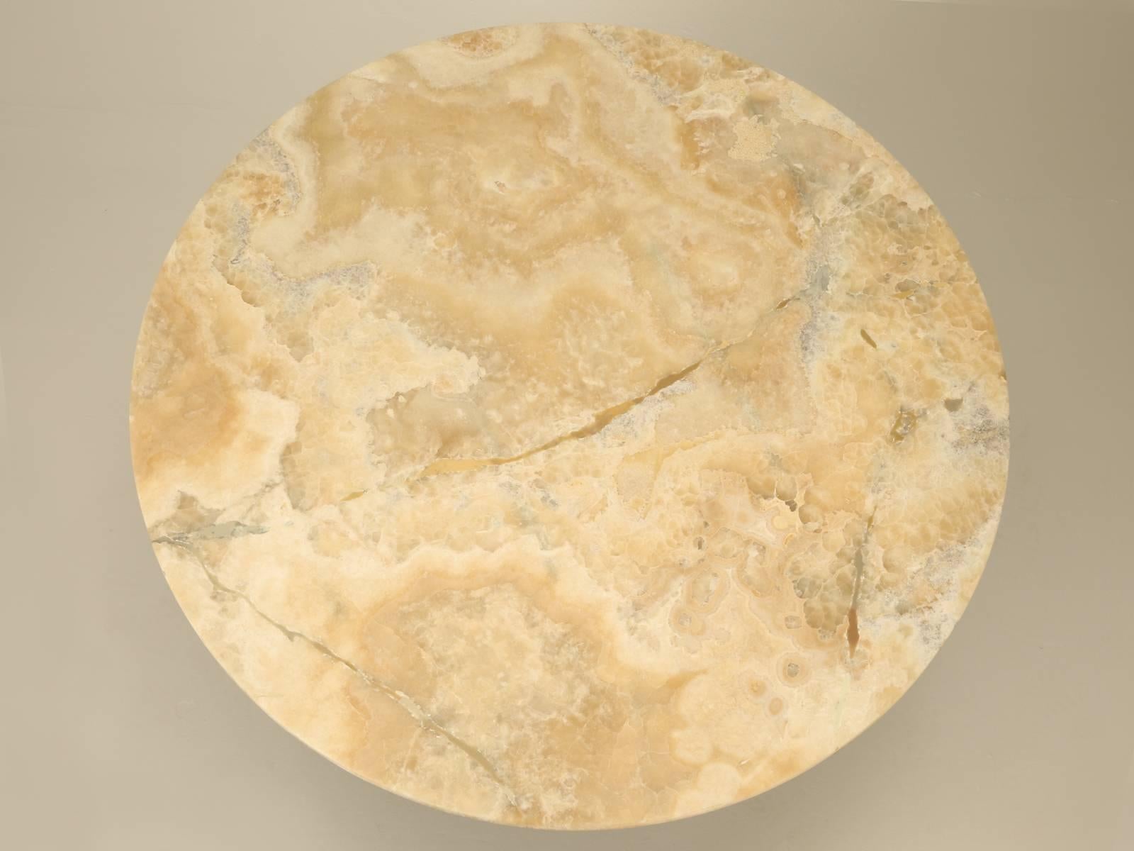 Onyx stone top and an extra heavy-duty stainless-steel pedestal base, make for an elegant dining table. The onyx is backed by a ¾” thick wood support, combined with an epoxy coating to strengthen it even further. There are signs of old repairs, but