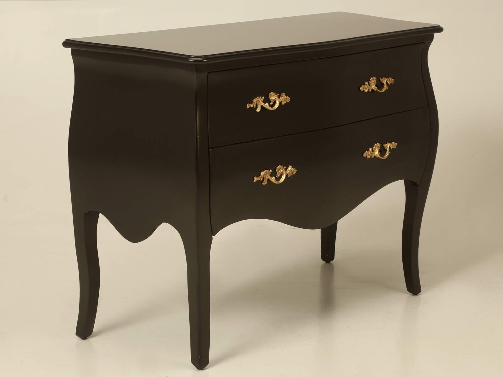 Reproduction French bombe chest or commode, finished in black lacquer that was imported from Holland quite a while ago. Constructed of solid wood and our Old Plank workshop just restored the painted finish, so it is free of any blemish.