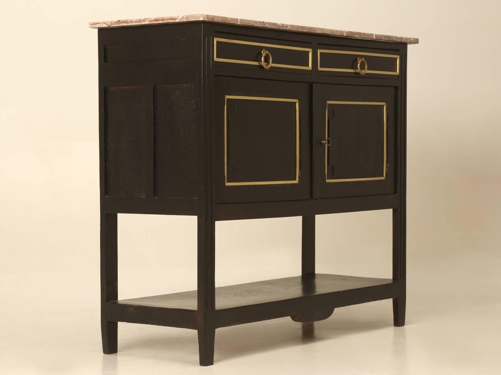 French Louis XVI style Ebonized small two-door Server or French Ebonized Buffet, with a lower shelf and marble top. Our Old Plank finishing department just completed a very nice ebonized finish, so there are no scratches to worry about and there are