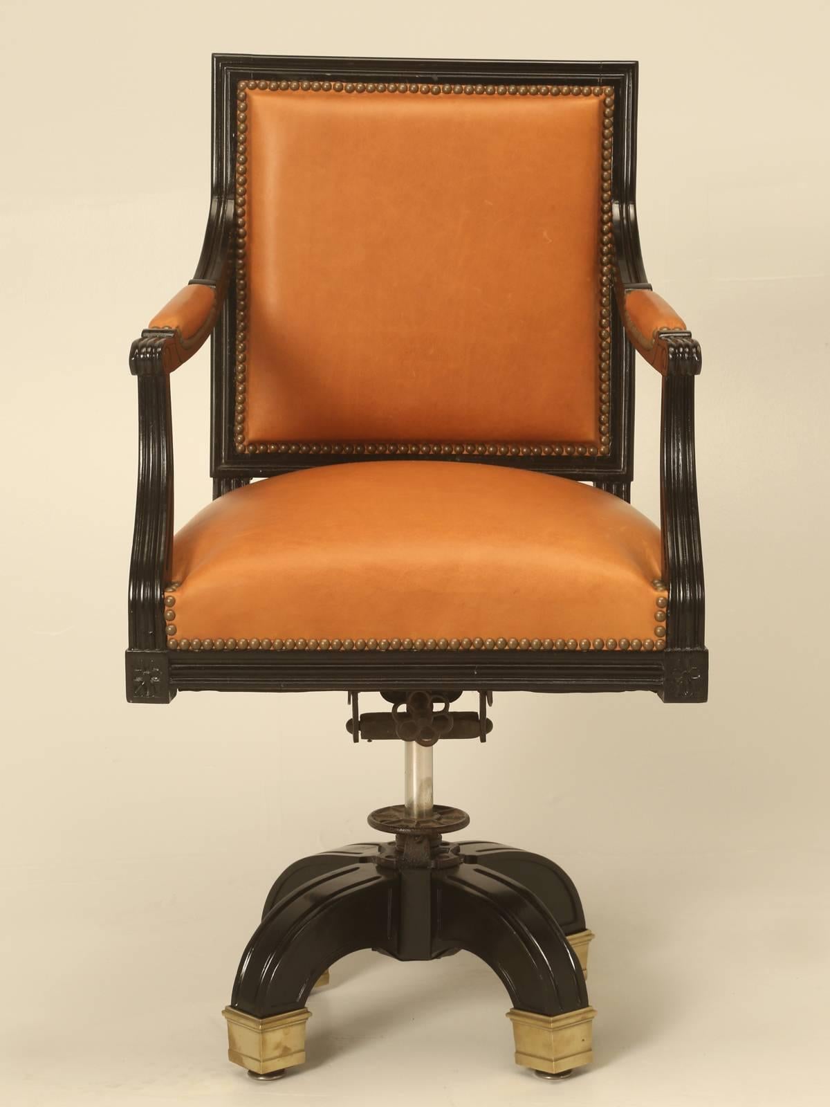 Vintage French Louis XVI style desk chair, done in an authentic French ebonized finish. The upholstery was just restored with glove soft leather imported from Italy, complete with old fashion horsehair padding, which lasts almost forever.