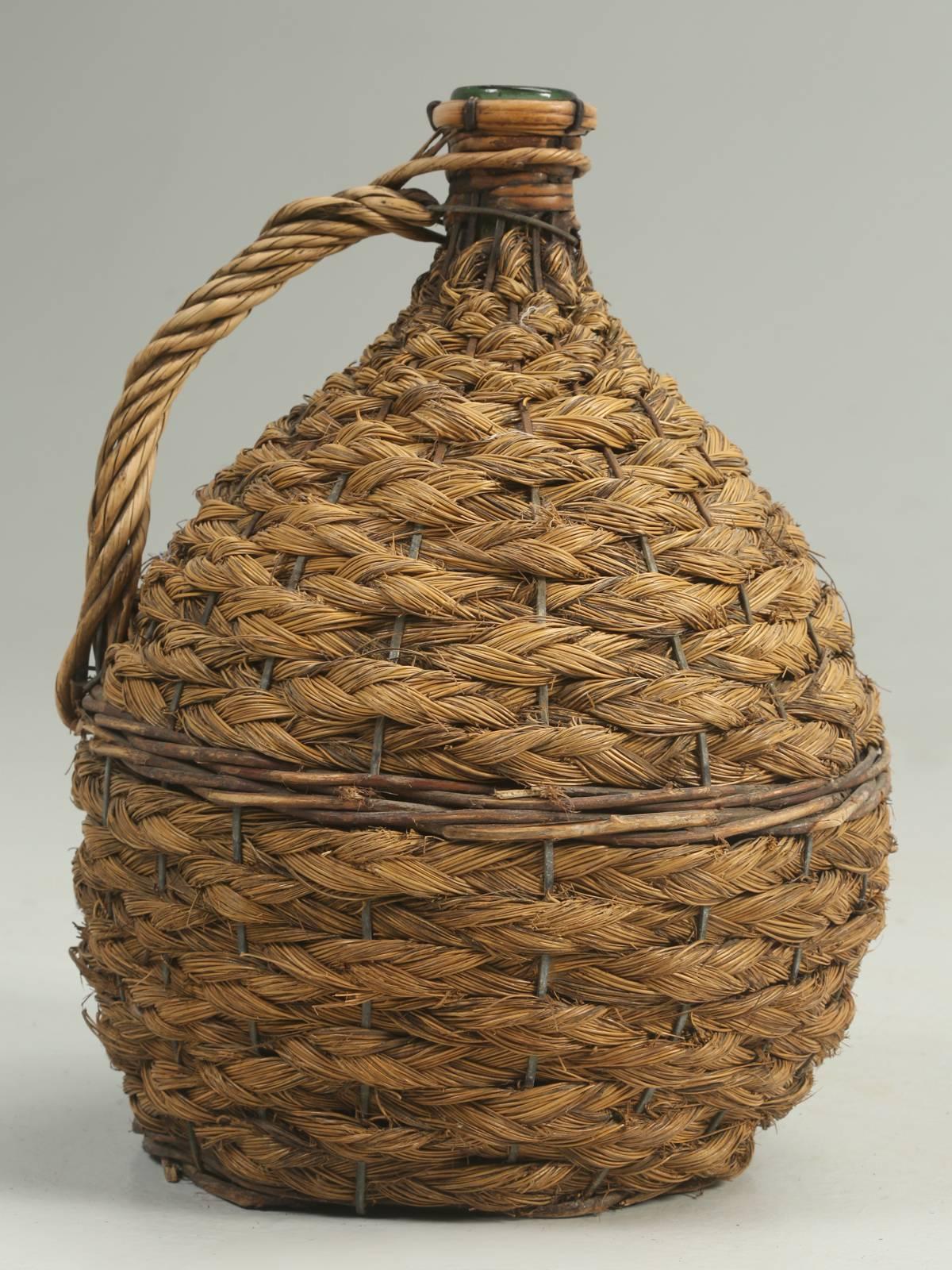 Antique Demijohn bottle, Demijohn, referring to any glass vessel with a large body and small neck and generally encased in wickerwork, thin slats of wood. The word originates from the French dame-jeanne, literally 