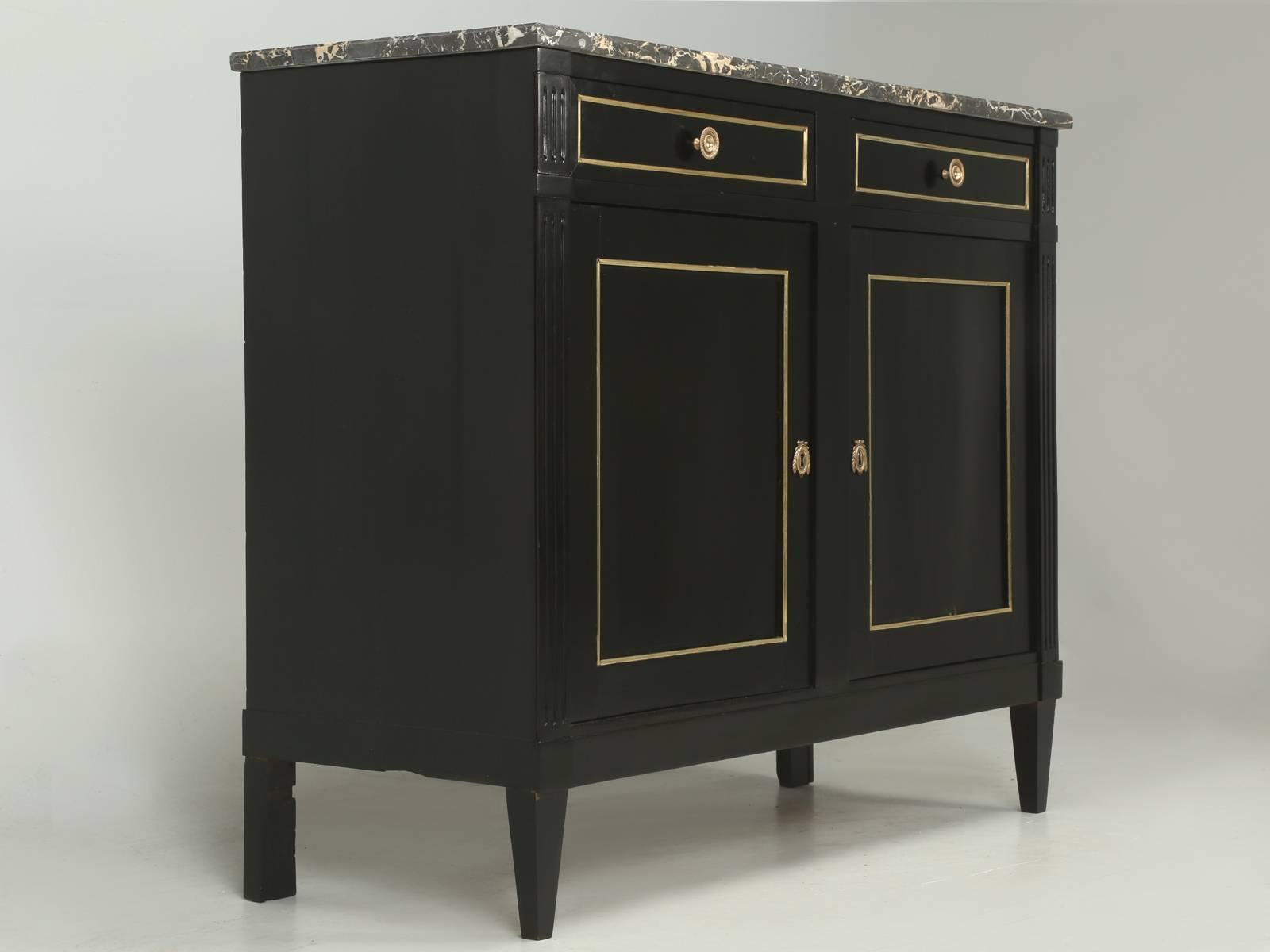 Antique French Louis XVI style buffet, redone in a correctly applied ebonized finish. Our old plank workshop, hand-scrapped the entire buffet and applied layer, upon layer of different stains, to match the appearance of a real antique ebony finish.