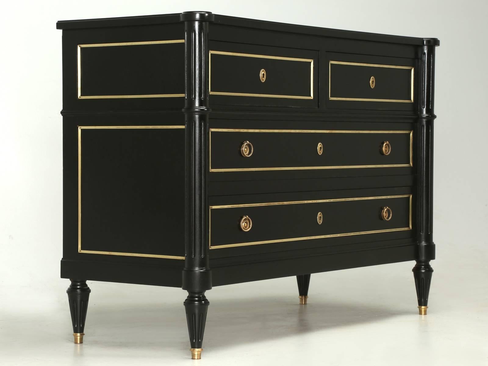 French Louis XVI style commode shown in an old world ebonized finish, where the grain of the mahogany still shows through the layers of black stain. Although not a true antique, (less than 100 years old) this French Louis XVI commode is old enough