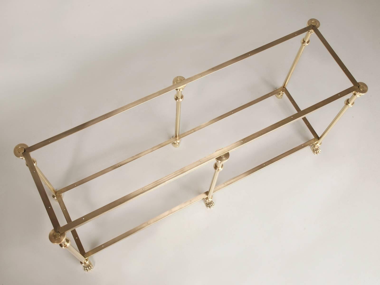 Custom Solid Hand-Polished Brass, two shelf Console Table, or could be resized into a Kitchen Island, with beautifully detailed Polished Brass Lion Paw Feet. Due to the fact that the Console shown here, was custom fabricated by our own metal