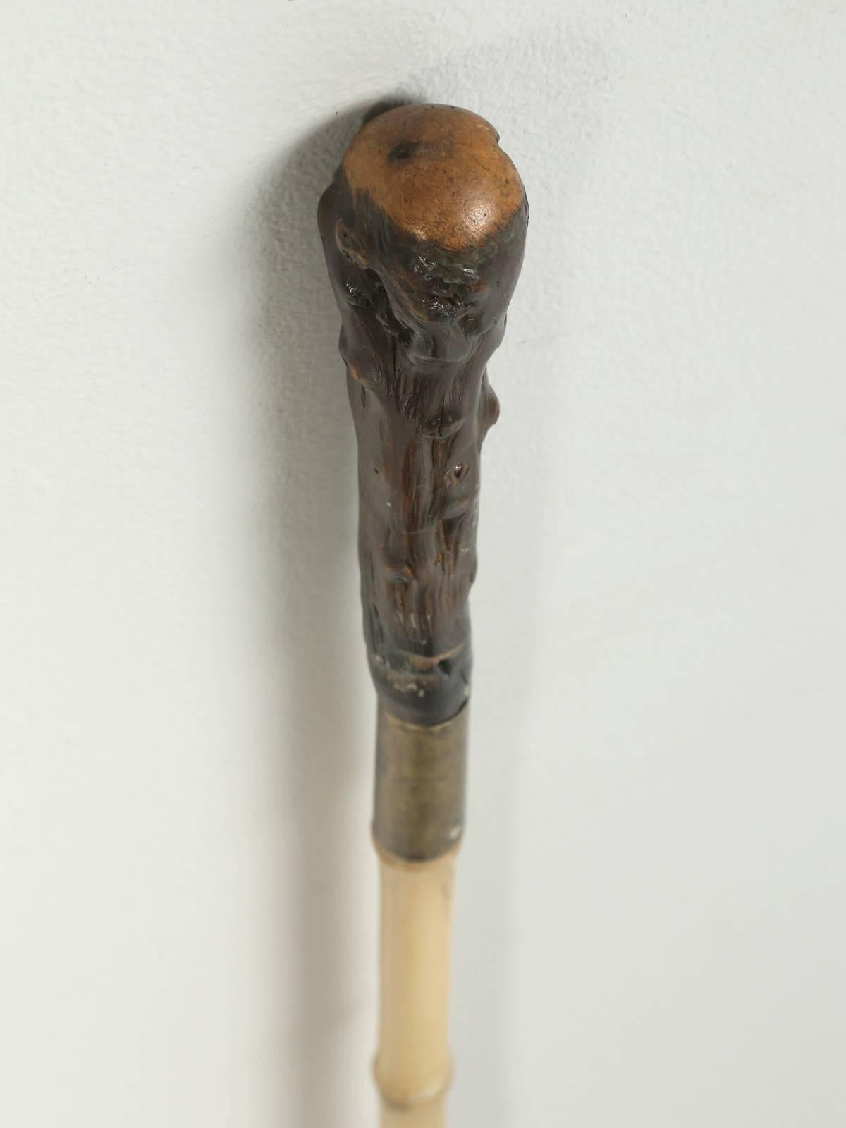 Antique bamboo walking stick, or cane from France that has a hidden sword resting inside of the bamboo. The handle appears to have been taken from the root of a tree and it rests on a brass band. The condition is nice and all we did was to apply a