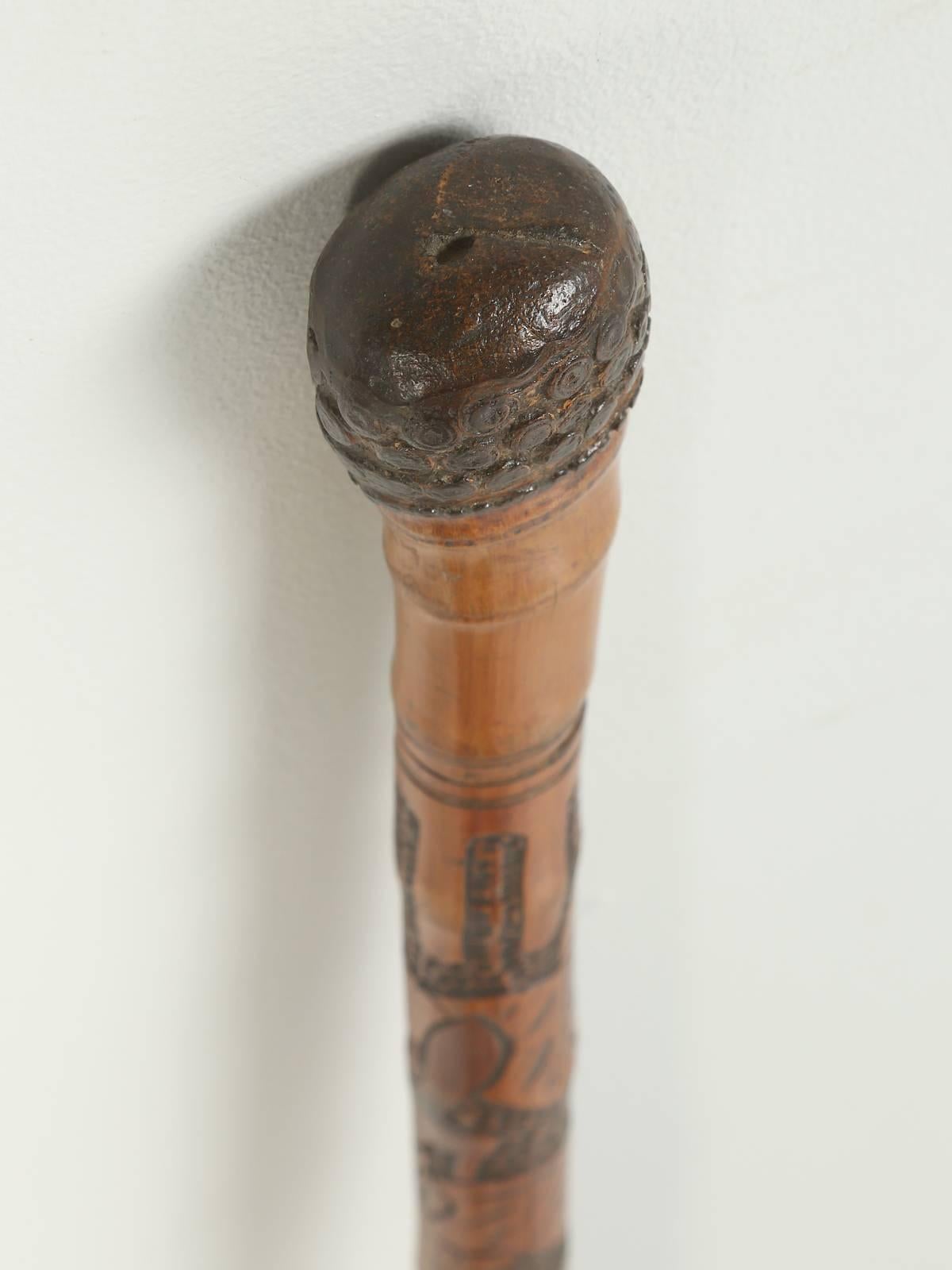 Antique bamboo walking stick, or cane imported from France, that has a large hidden Sword built into the interior of the bamboo. The knob at the top appears to be part of the bamboo itself and there is a large steel ferrule at the bottom. The