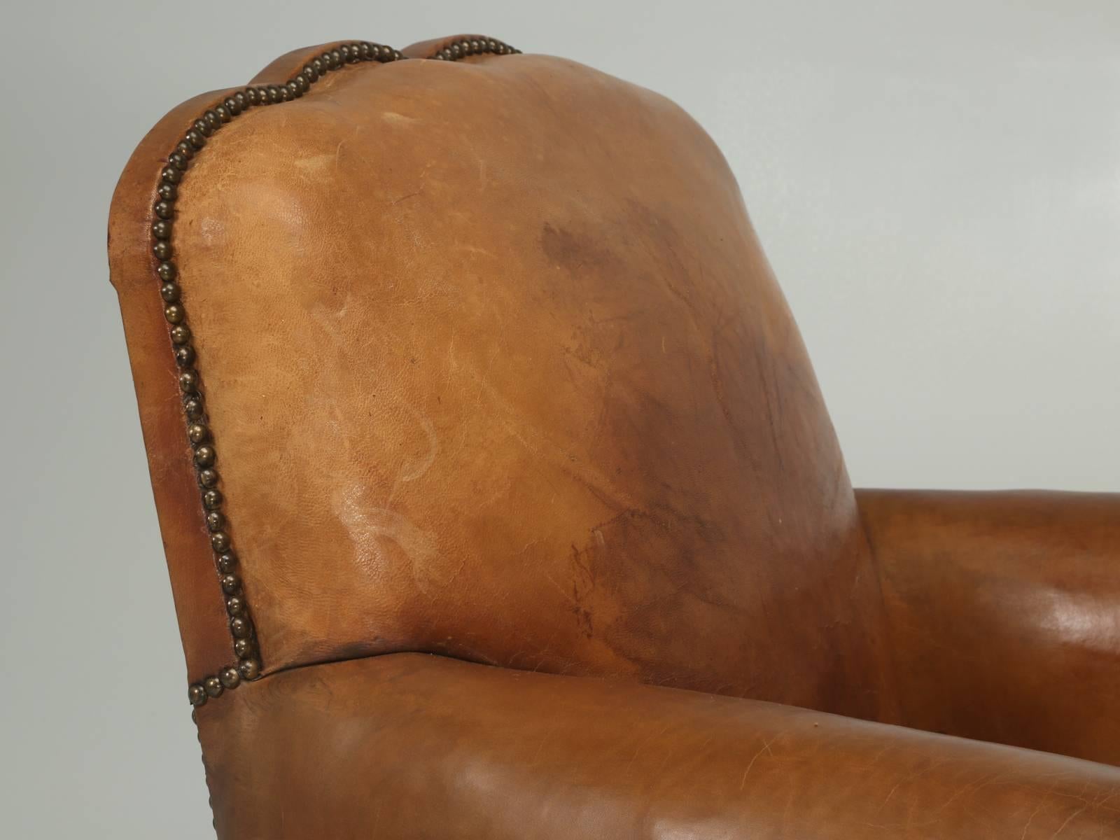 Another great original pair of French Art Deco leather club chairs that are actually part of a four-club chair suite. We have split the set of leather club chairs and are offering them in pairs. Each chair was carefully disassembled, checked for