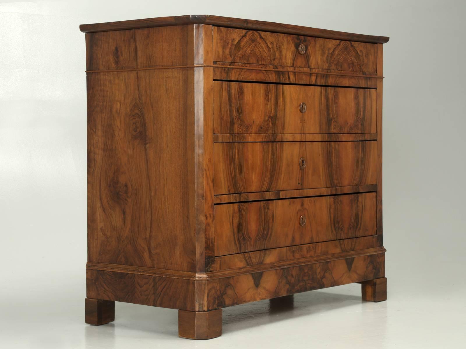Antique French Louis Philippe commode or chest of drawers in bookmatched walnut. Our Old Plank restoration department, spent over 30-days restoring this antique French commode. We started by rebuilding the interior, so that the drawers would slide,