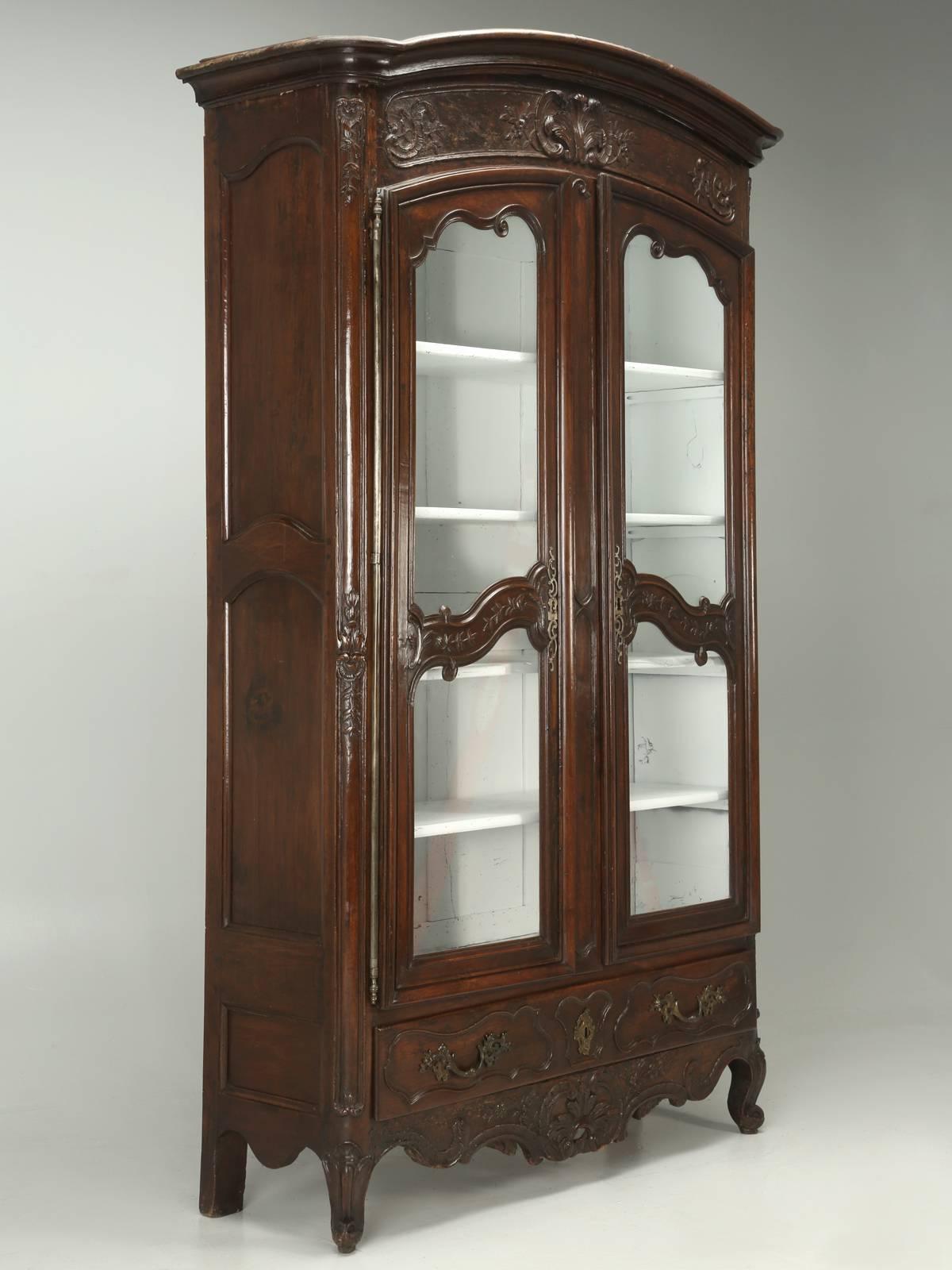 Antique French Walnut China Cabinet, Vitrine, Bookcase or Armoire, probably constructed over 200-years ago. Our Old Plank restoration department, went through the Armoires structure, from the inside out and our finishers, tried to do as little as