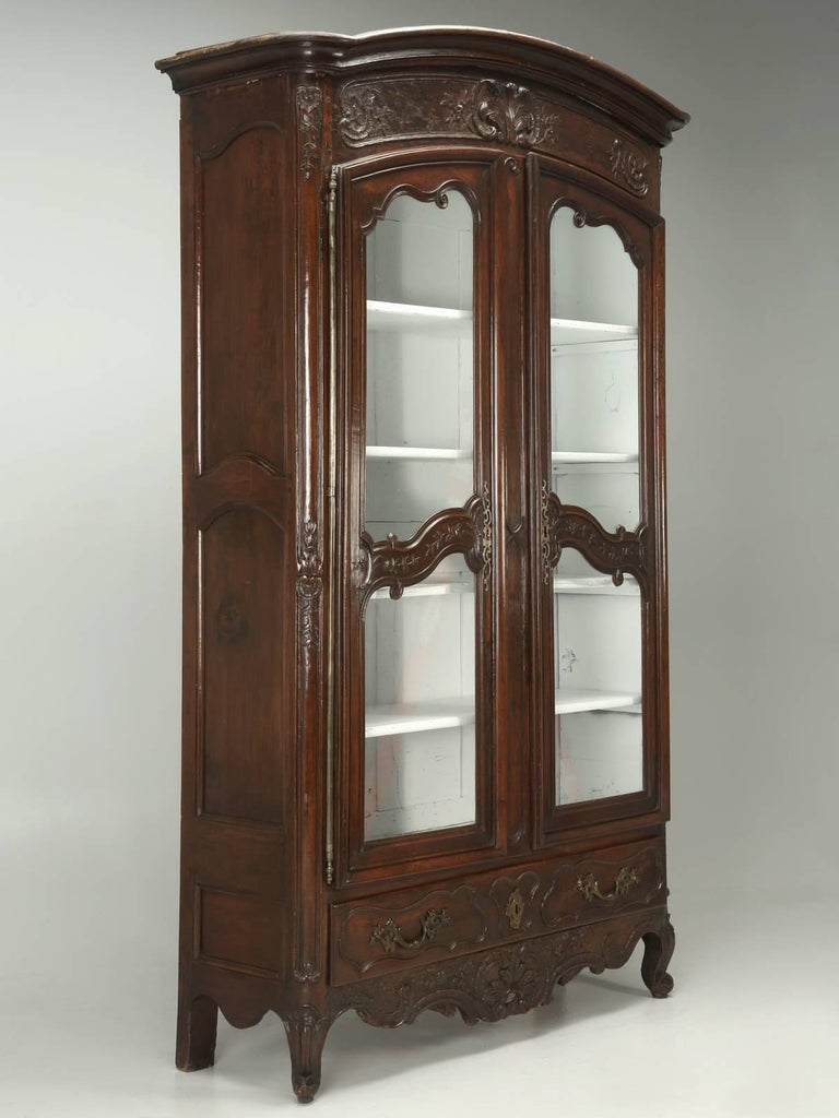 Antique French walnut china cabinet, or armoire, probably constructed over 200-years ago. Our Old Plank restoration department, went through the armoires structure, from the inside out and our finishers, tried to do as little as possible to the